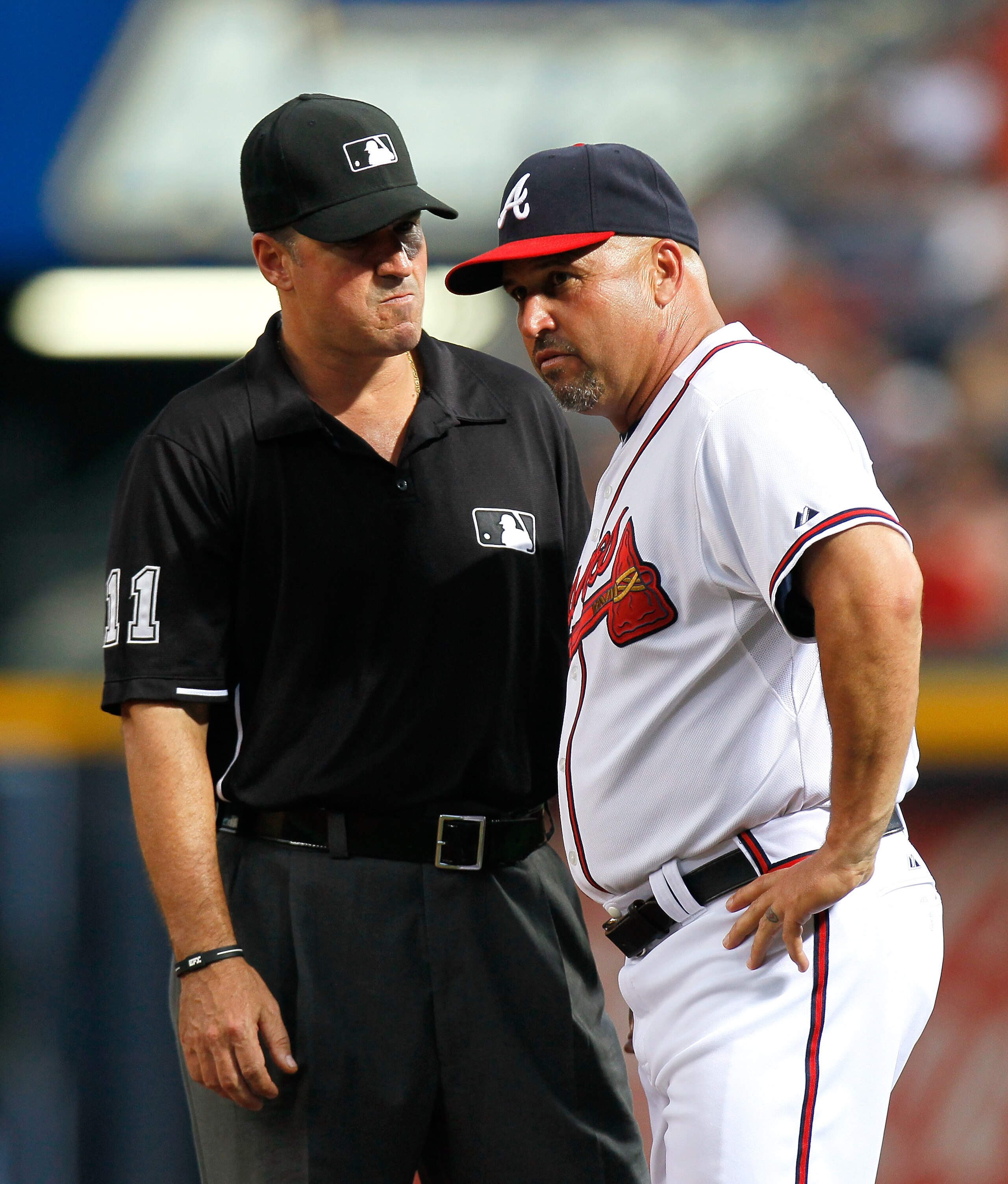 ATLANTA, GA - JUNE 01:  Fredi Gonzalez #33 of the Atlanta Braves and first base umpire Tony Randazzo #11 against the San Diego Padres at Turner Field on June 1, 2011 in Atlanta, Georgia.  (Photo by Kevin C. Cox/Getty Images)
