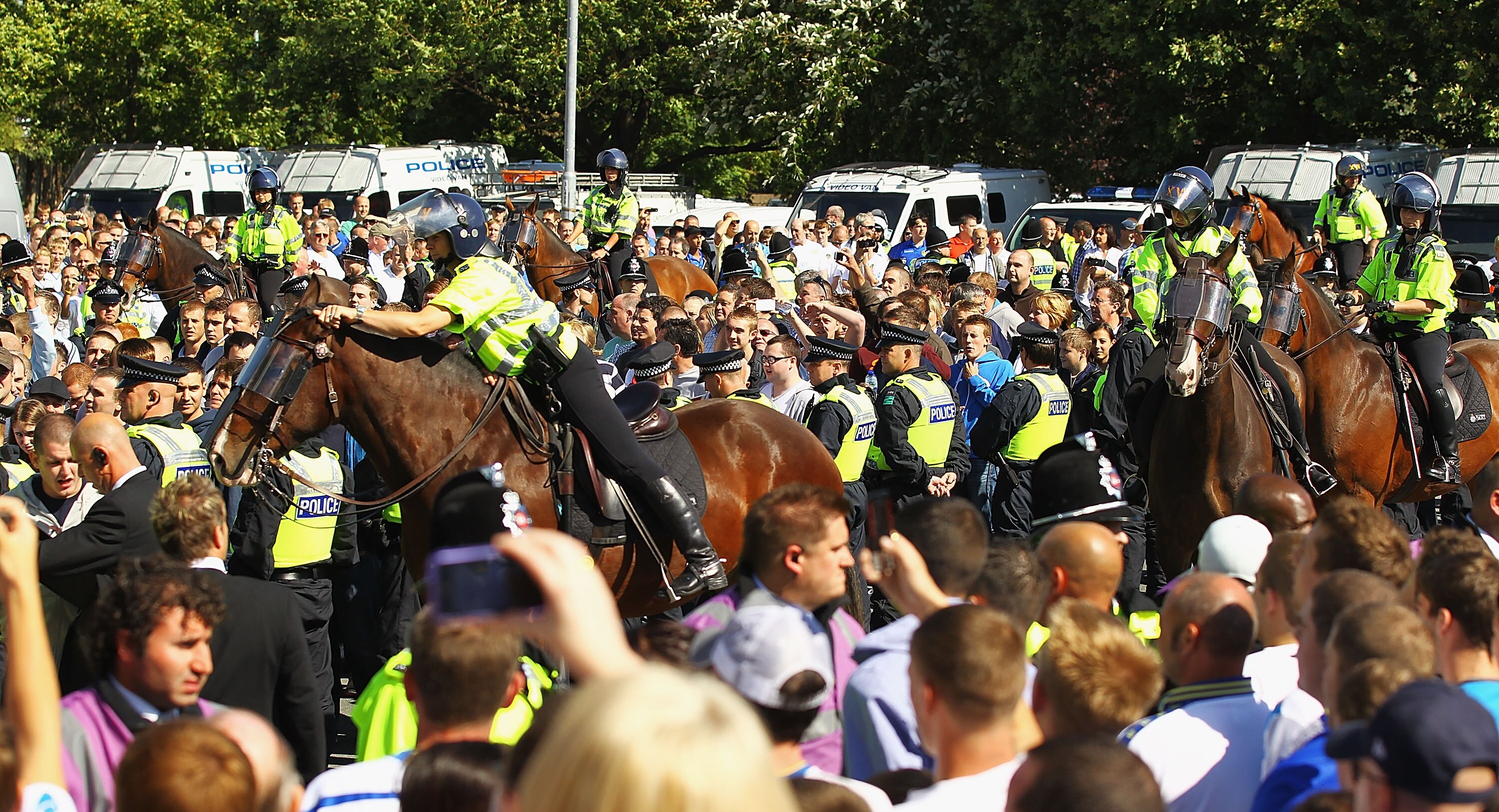 LEEDS, ENGLAND - AUGUST 21:  Police escort the Millwall supporters into the ground ahead of the Npower Championship match between Leeds United and Millwall at Elland Road on August 21, 2010 in Leeds, England.  (Photo by Matthew Lewis/Getty Images)