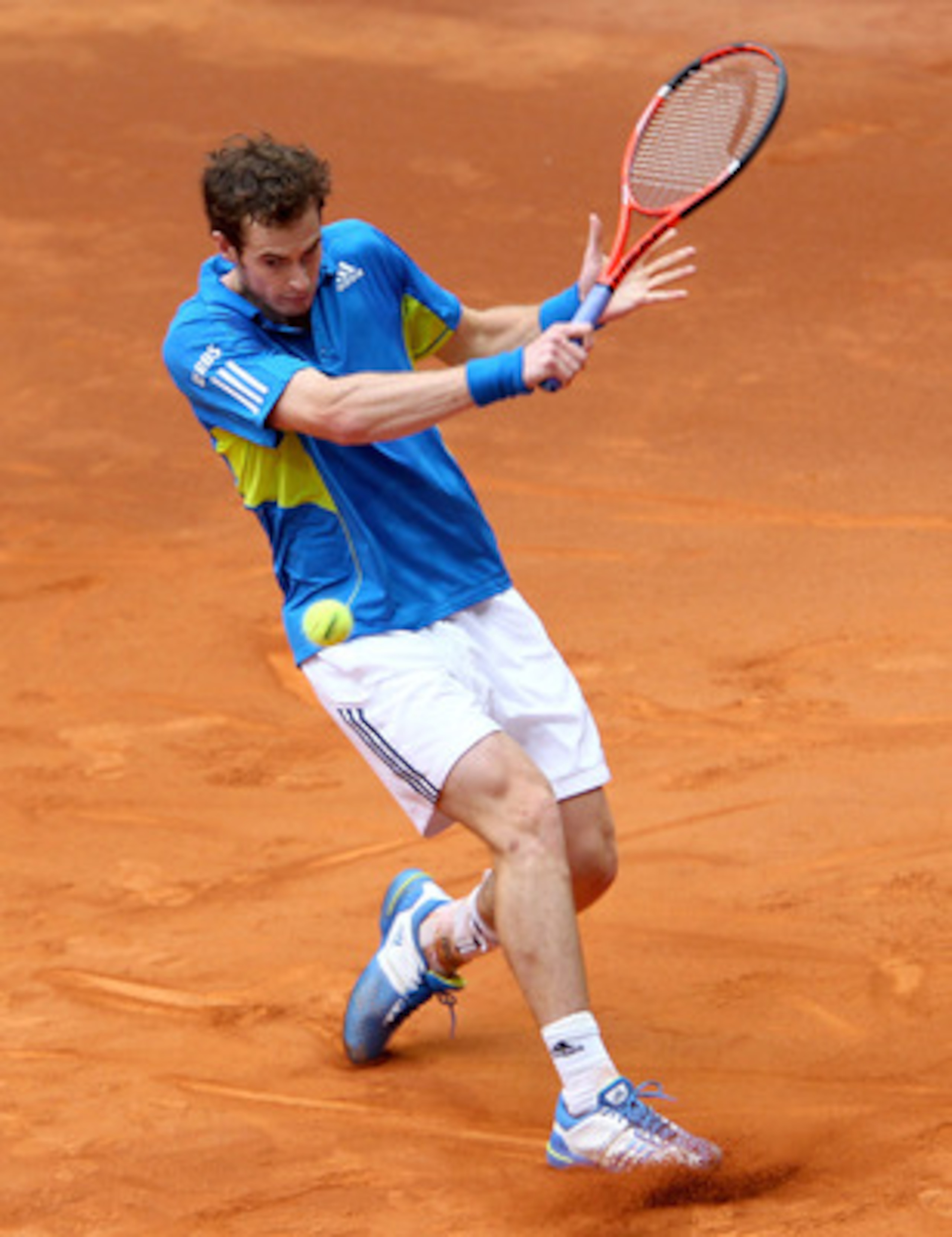 MADRID, SPAIN - MAY 12:  Andy Murray of Great Britain slides on the clay to play a backhand against Juan Ignacio Chela of Argentina in their second round match during the Mutua Madrilena Madrid Open tennis tournament at the Caja Magica on May 12, 2010 in 