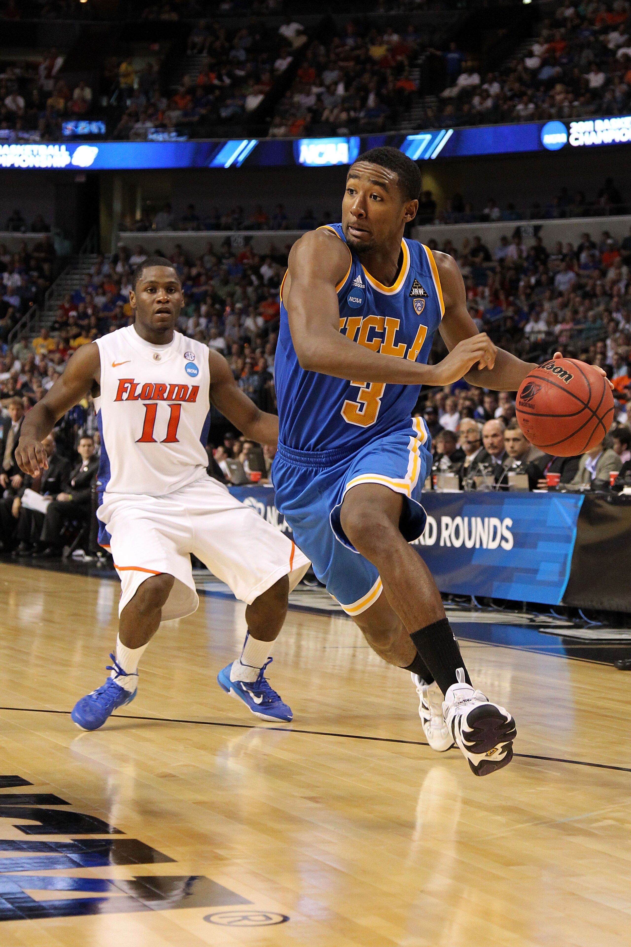 TAMPA, FL - MARCH 19:  Malcolm Lee #3 of the UCLA Bruins drives against Erving Walker #11 of the Florida Gators during the third round of the 2011 NCAA men's basketball tournament at St. Pete Times Forum on March 19, 2011 in Tampa, Florida.  (Photo by Mik