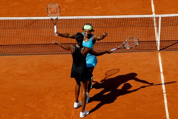 PARIS - JUNE 04:  Serena Williams and Venus Williams of the United States celebrate winning match point during the women's doubles final between Serena Williams and Venus Williams of the United States and Kveta Peschke of Czech Republic and Katarina Srebo