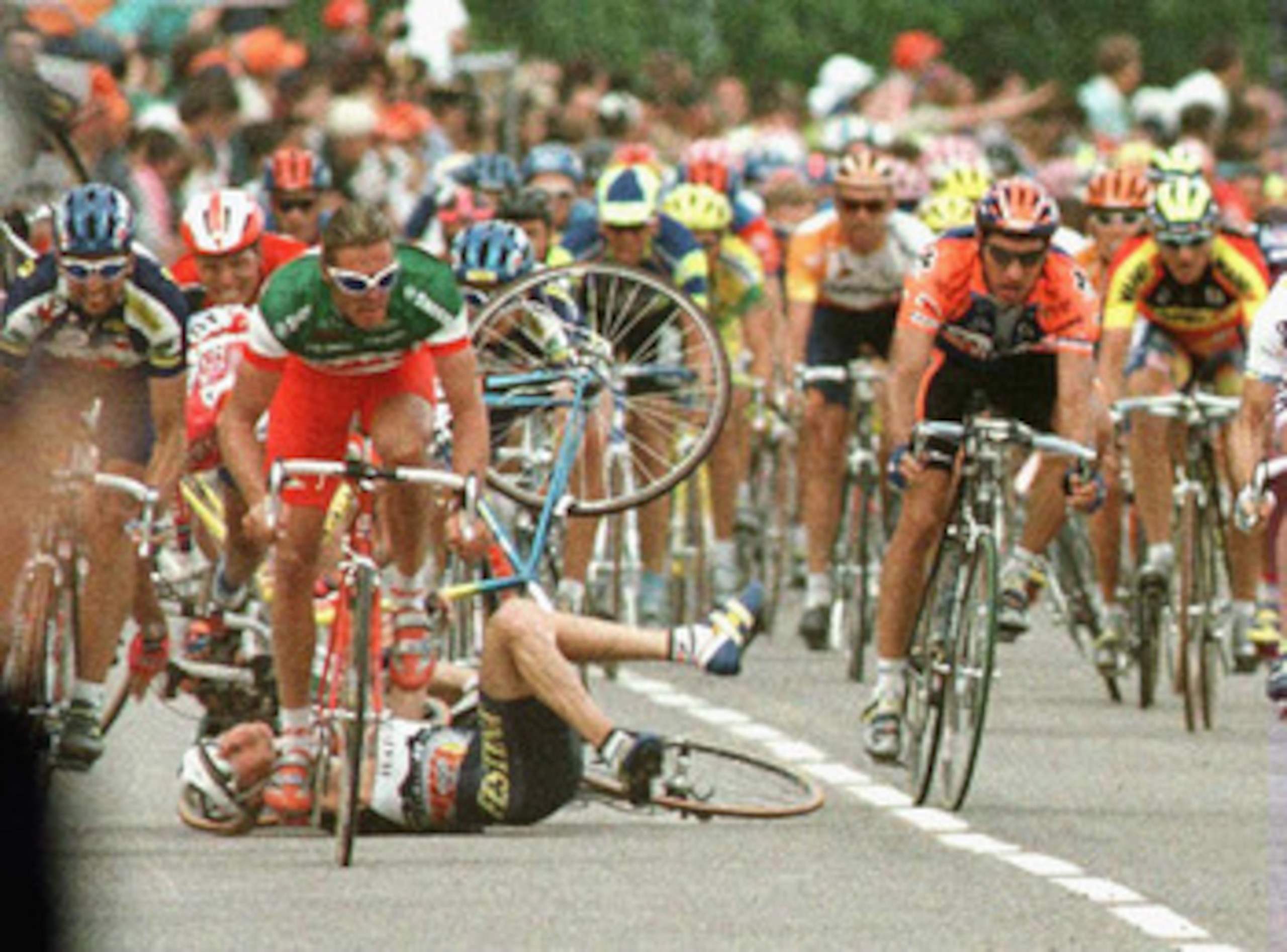 LAC DE MADINE, FRANCE - JULY 3:  During the peloton sprint three riders crash - Mauro Bettin of Italy, Laurent Brochard of France and Jan Svorada - as Mario Cipollini of Italy (foreground) escapes from the pileup during stage four on July 3, 1996 of the T