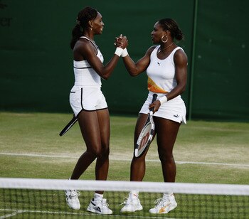 LONDON - JUNE 30:  Venus and Serena Williams of the USA celebrate winning their Ladies Doubles match on the seventh day of the Wimbledon Lawn Tennis Championships held on June 30, 2003 at the All England Lawn Tennis and Croquet Club, in London. (Photo by 