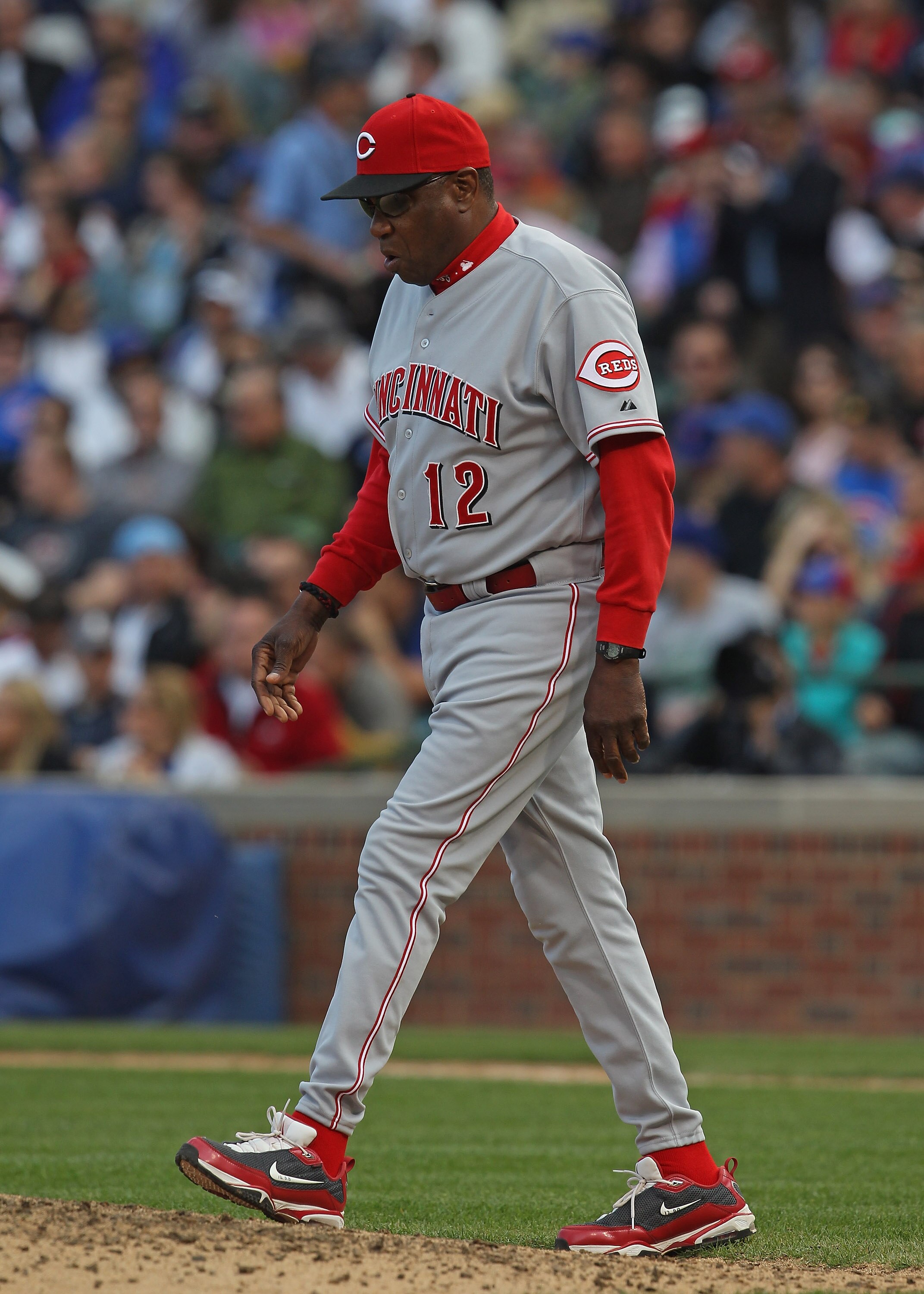 CHICAGO, IL - MAY 06: Manager Dusty Baker #12 of the Cincinnati Reds walks to the mound to make a pitching change against the Chicago Cubs at Wrigley Field on May 6, 2011 in Chicago, Illinois. The Reds defeated the Cubs 5-4. (Photo by Jonathan Daniel/Gett