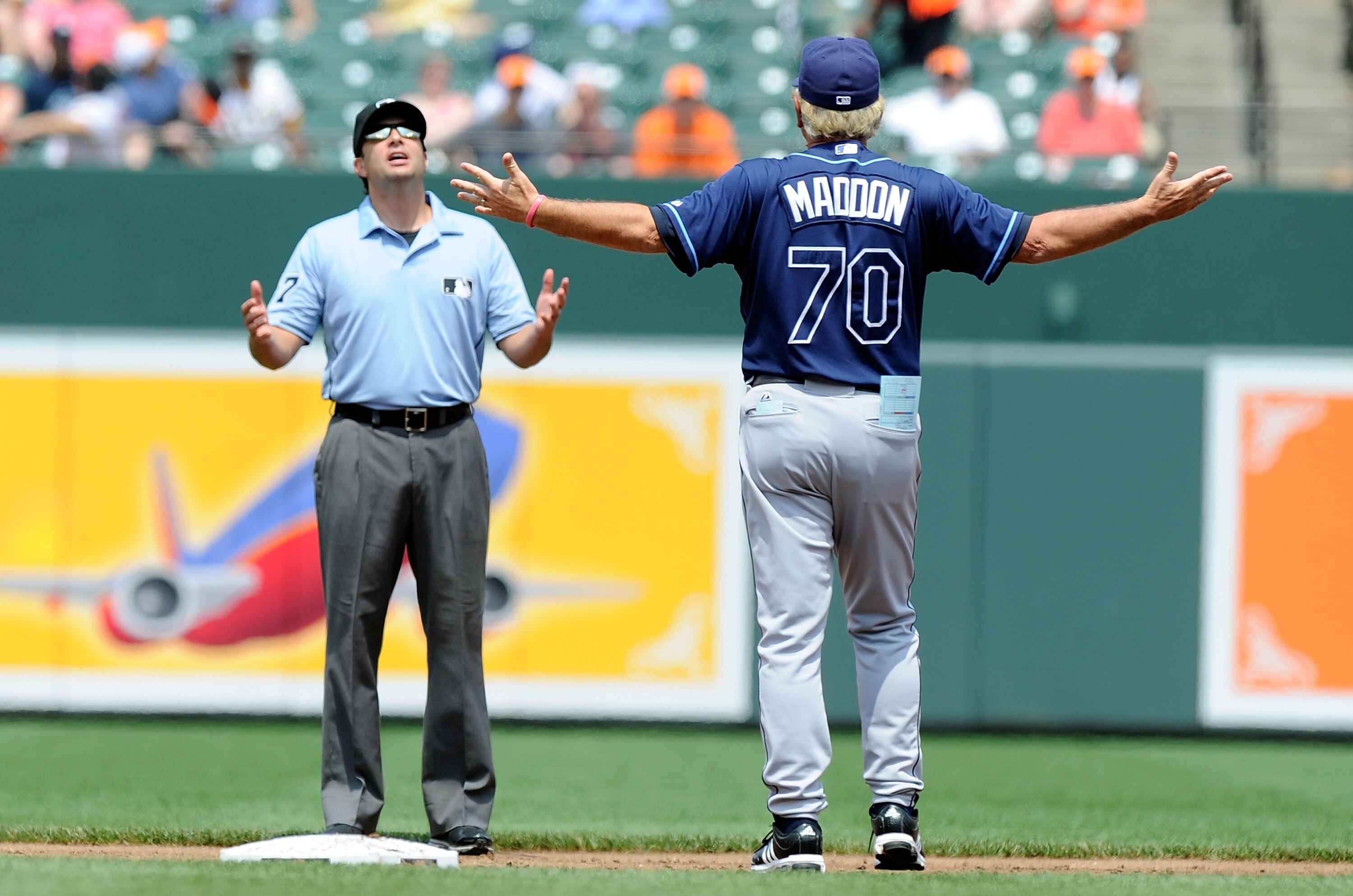 BALTIMORE, MD - JUNE 12:  Manager Joe Maddon #70 of the Tampa Bay Rays argues with second base umpire Jim Reynolds during the second inning of the game against the Baltimore Orioles at Oriole Park at Camden Yards on June 12, 2011 in Baltimore, Maryland.