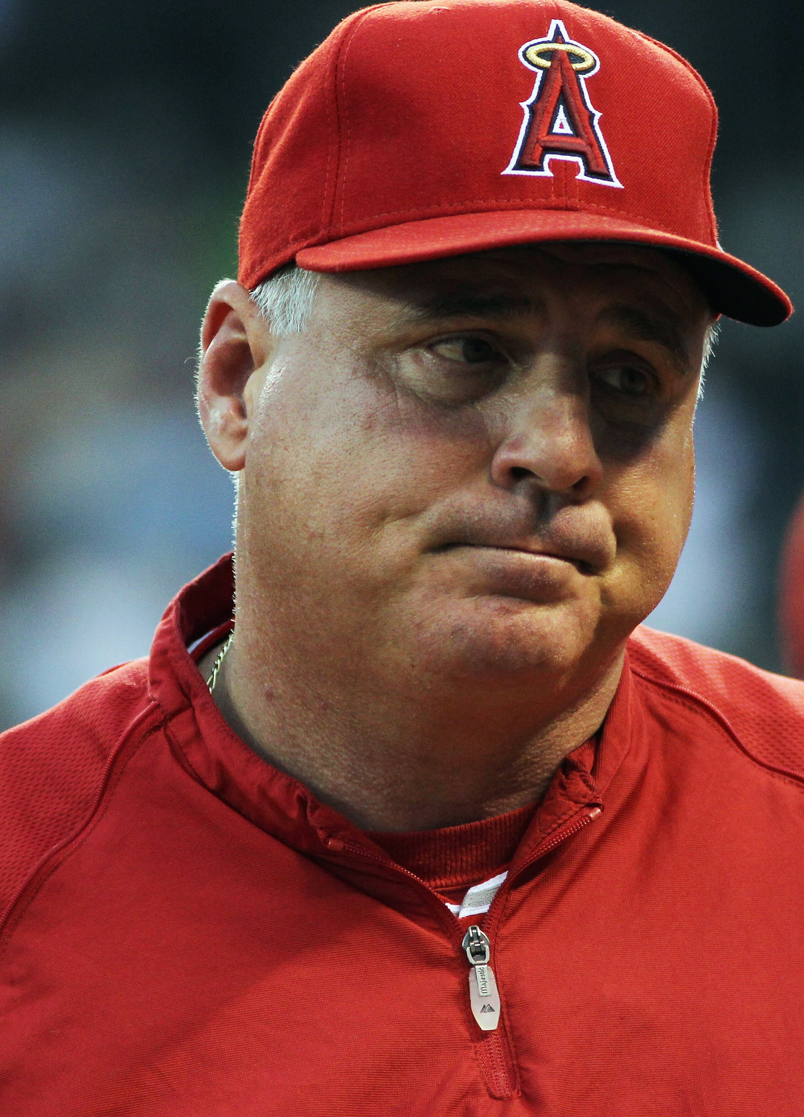 KANSAS CITY, MO - JUNE 01:  Manager Mike Scioscia #14 of the Los Angeles Angels of Anaheim reacts after umpires overturned a ground-rule-double ruling on the field to give the Kansas City Royals a 2-run home run to win the game on June 1, 2011 at Kauffman
