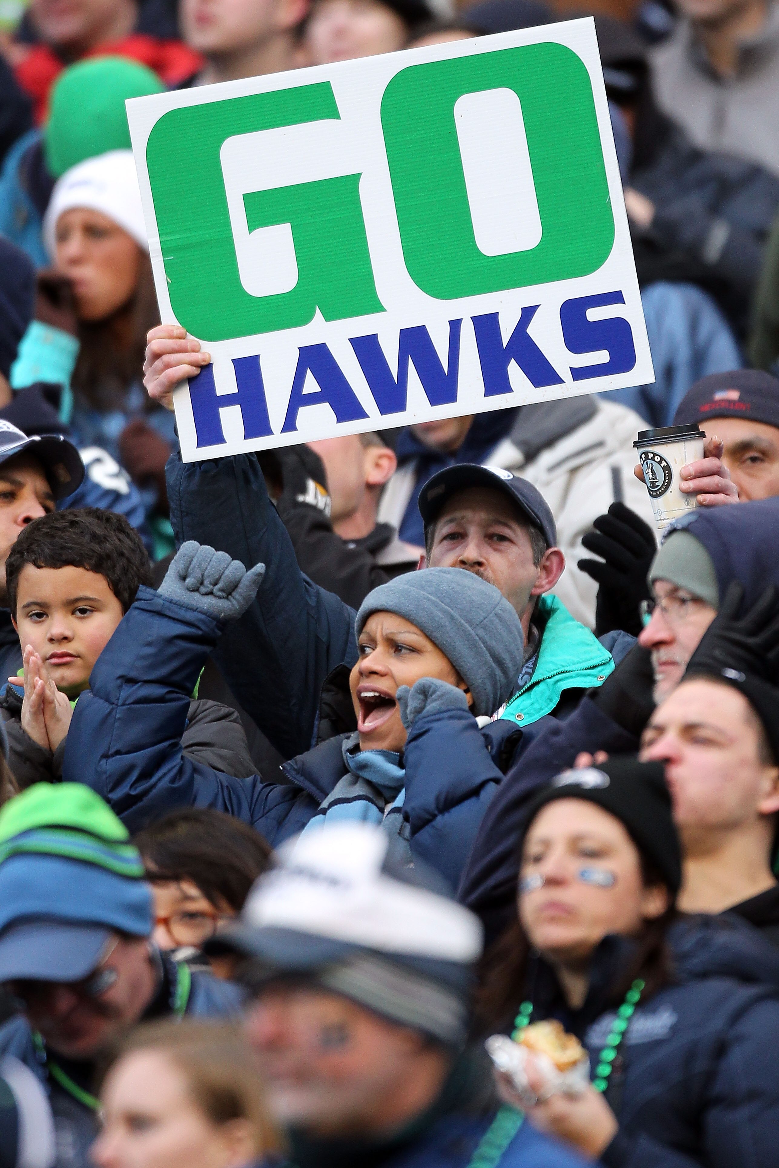 SEATTLE, WA - JANUARY 08:  Fans of the Seattle Seahawks cheer in the second half as the Seahawks take on the New Orleans Saints during the 2011 NFC wild-card playoff game at Qwest Field on January 8, 2011 in Seattle, Washington.  (Photo by Otto Greule Jr/