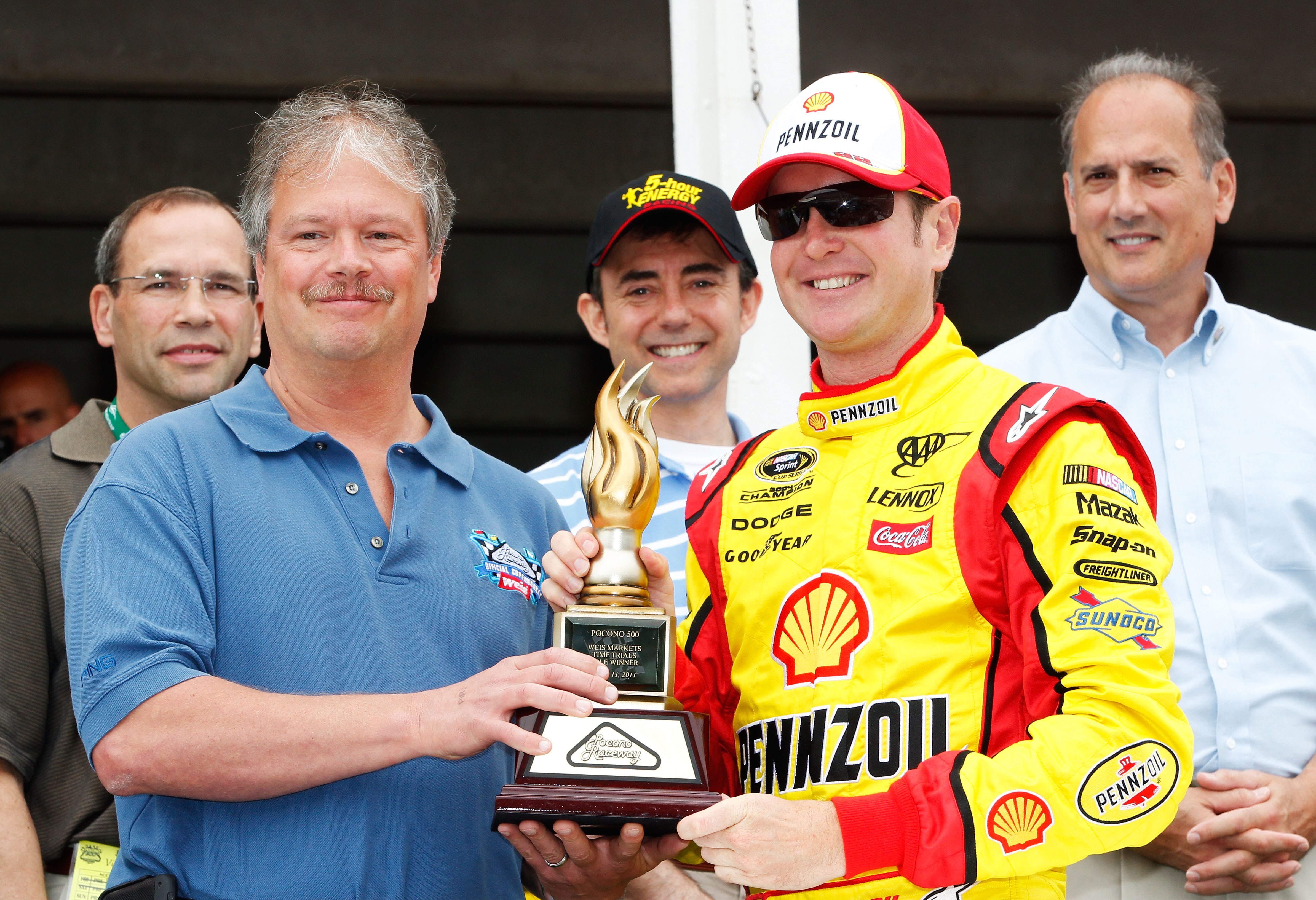 LONG POND, PA - JUNE 12:  Kurt Busch (R), driver of the #22 Shell/Pennzoil Dodge, recieves the Weis poll award prior to the NASCAR Sprint Cup Series 5-Hour Energy 500 at Pocono Raceway on June 12, 2011 in Long Pond, Pennsylvania.  (Photo by Geoff Burke/Ge