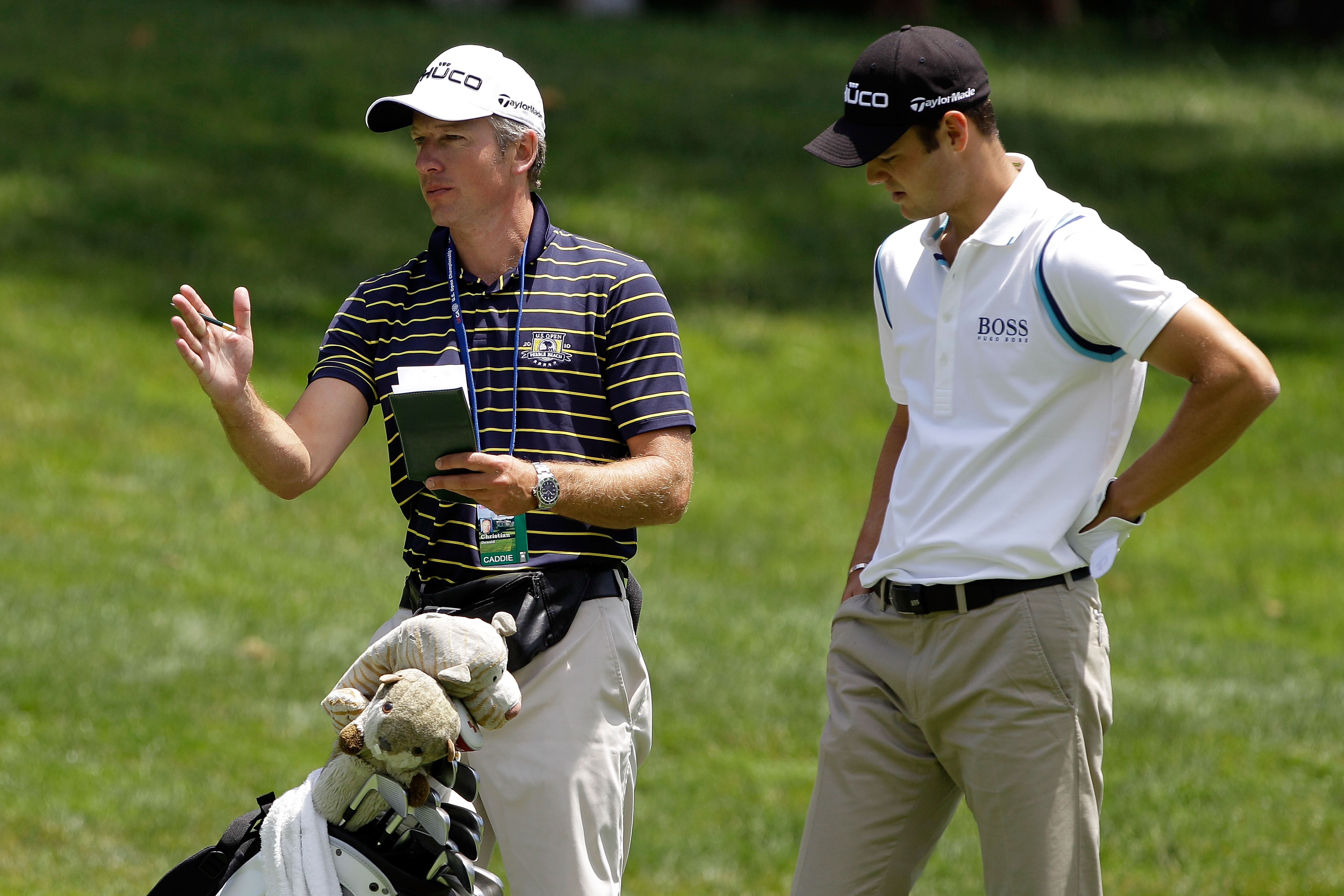 BETHESDA, MD - JUNE 13:  Martin Kaymer of Germany (R) chats with his caddie Christian Donald during a practice round prior to the start of the 111th U.S. Open at Congressional Country Club on June 13, 2011 in Bethesda, Maryland.  (Photo by Rob Carr/Getty