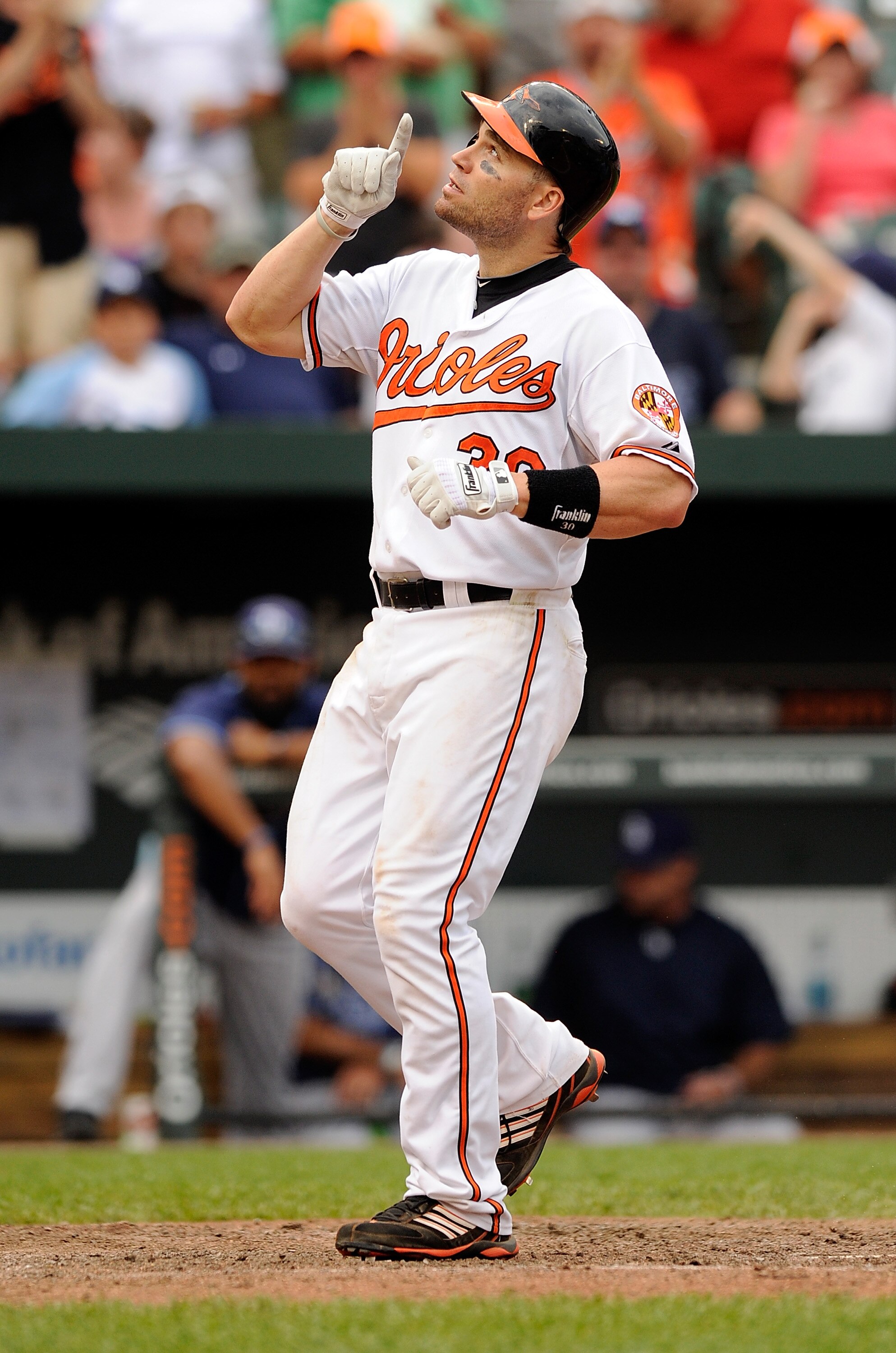 BALTIMORE, MD - JUNE 12:  Luke Scott #30 of the Baltimore Orioles celebrates after hitting a home run in the eighth inning against the Tampa Bay Rays at Oriole Park at Camden Yards on June 12, 2011 in Baltimore, Maryland.  (Photo by Greg Fiume/Getty Image