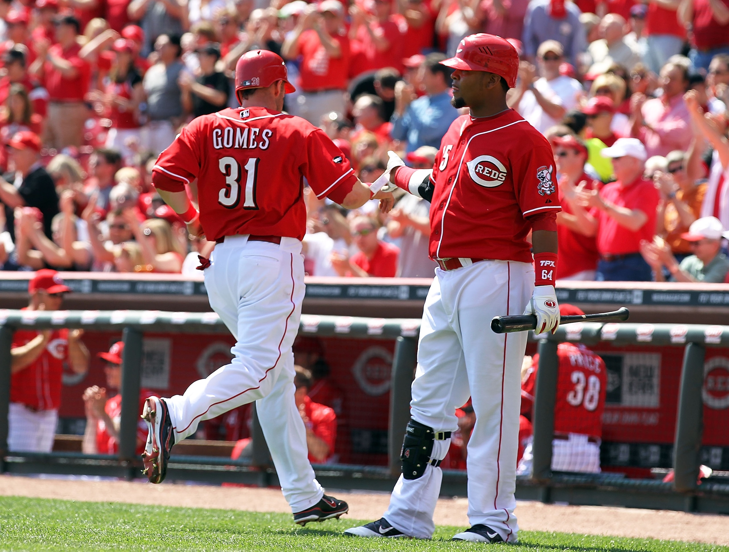 CINCINNATI, OH - APRIL 07: Jonny Gomes #31 of the Cincinnati Reds is congratulated by Juan Francisco #25 after Gomes scored on a hit by Edgar Renteria during the game against the Houston Astros at Great American Ball Park on April 7, 2011 in Cincinnati, CINCINNATI, OH - APRIL 07: Jonny Gomes #31 of the Cincinnati Reds is congratulated by Juan Francisco #25 after Gomes scored on a hit by Edgar Renteria during the game against the Houston Astros at Great American Ball Park on April 7, 2011 in Cincinnati,
