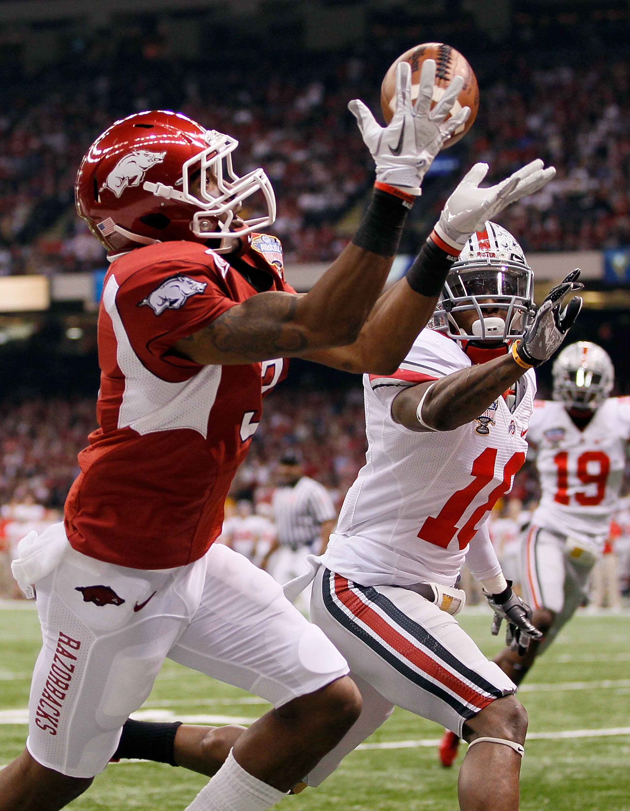 NEW ORLEANS, LA - JANUARY 04:  Joe Adams #3 of the Arkansas Razorbacks catches a 17-yard touchdown pass in the endzone against Travis Howard #18 of the Ohio State Buckeyes in the first quarter during the Allstate Sugar Bowl at the Louisiana Superdome on J