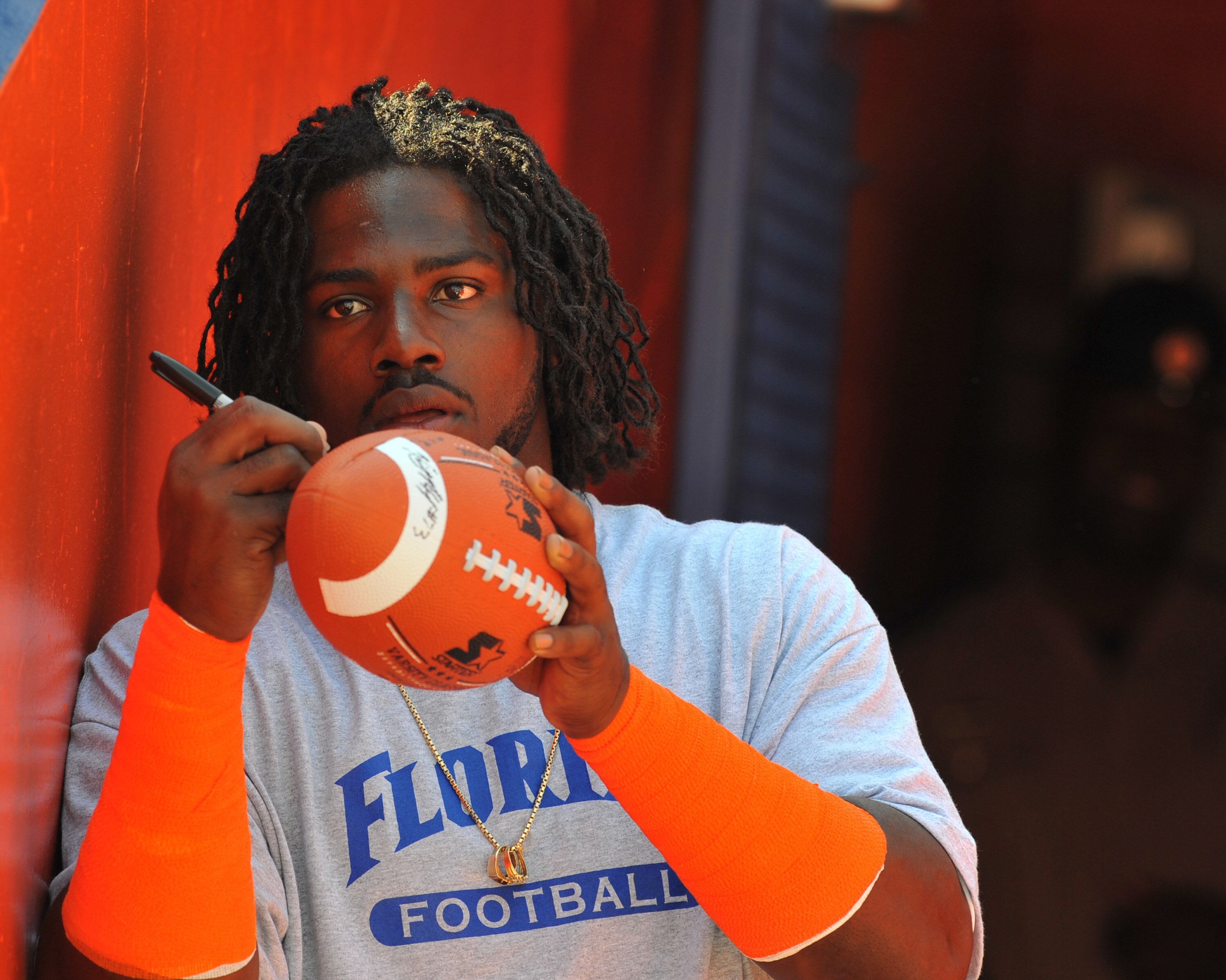 GAINESVILLE, FL - APRIL 9:  Linebacker Ronald Powell #7 of the Florida Gators signs an autograph before the Orange and Blue spring football game April 9, 2011 at Ben Hill Griffin Stadium in Gainesville, Florida.  (Photo by Al Messerschmidt/Getty Images)