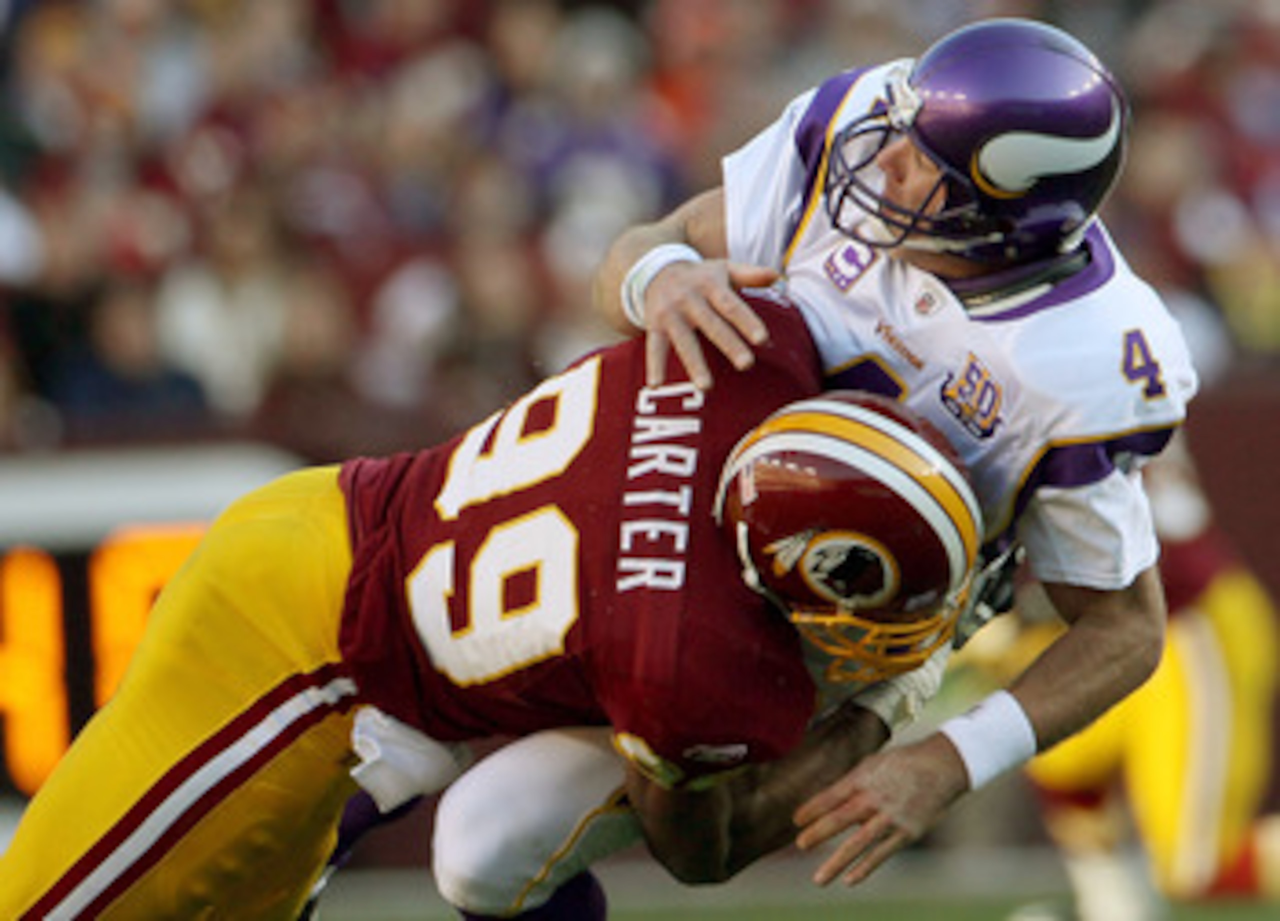 LANDOVER, MD - NOVEMBER 28: Brett Favre #4 of the Minnesota Vikings is hit by Washington Redskins linebacker Andre Carter #99 at FedExField November 28, 2010 in Landover, Maryland. The Vikings won the game 17-13. (Photo by Win McNamee/Getty Images) LANDOVER, MD - NOVEMBER 28: Brett Favre #4 of the Minnesota Vikings is hit by Washington Redskins linebacker Andre Carter #99 at FedExField November 28, 2010 in Landover, Maryland. The Vikings won the game 17-13. (Photo by Win McNamee/Getty Images)