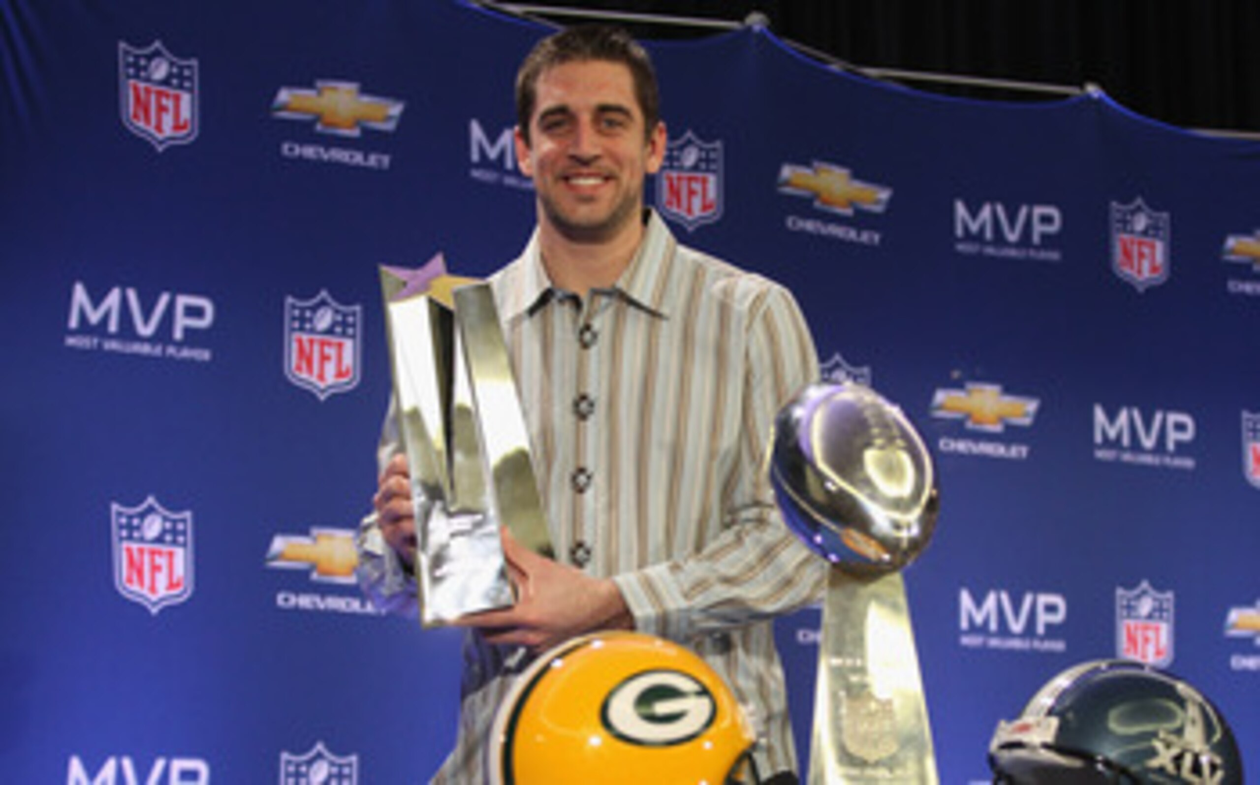 DALLAS, TX - FEBRUARY 07:  Green Bay Packers quarterback Aaron Rodgers poses with the MVP trophy after speaking to the media during a press conference at Super Bowl XLV Media Center on February 7, 2011 in Dallas, Texas.  (Photo by Streeter Lecka/Getty Ima