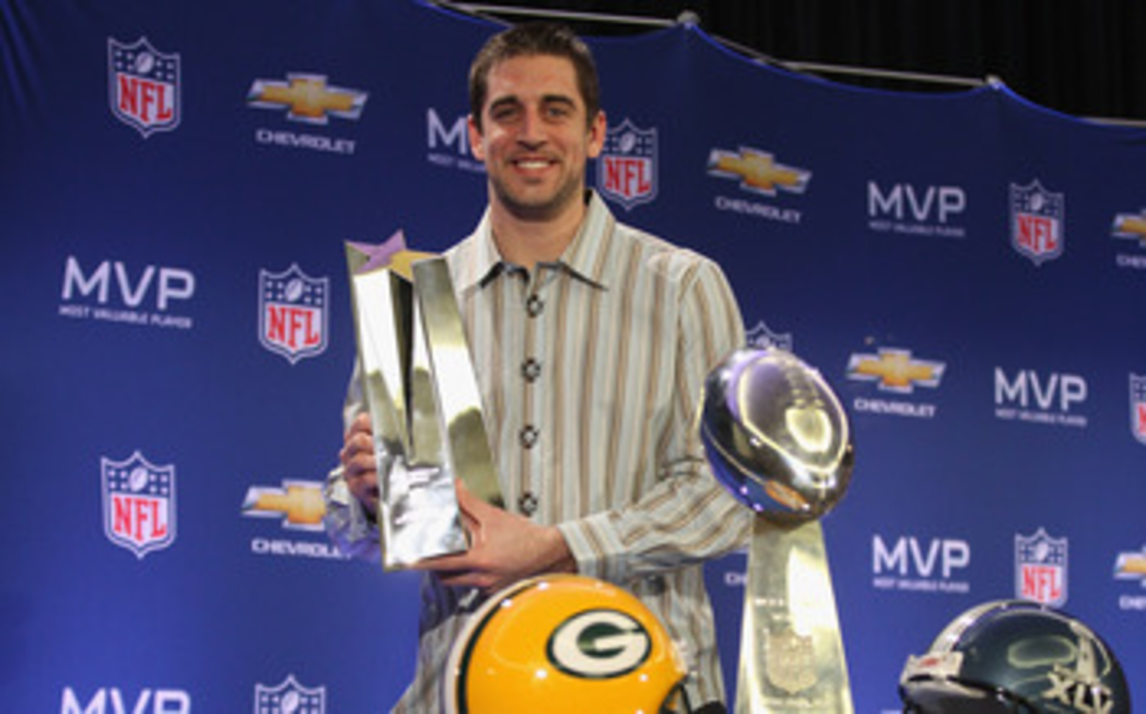 DALLAS, TX - FEBRUARY 07:  Green Bay Packers quarterback Aaron Rodgers poses with the MVP trophy after speaking to the media during a press conference at Super Bowl XLV Media Center on February 7, 2011 in Dallas, Texas.  (Photo by Streeter Lecka/Getty Ima
