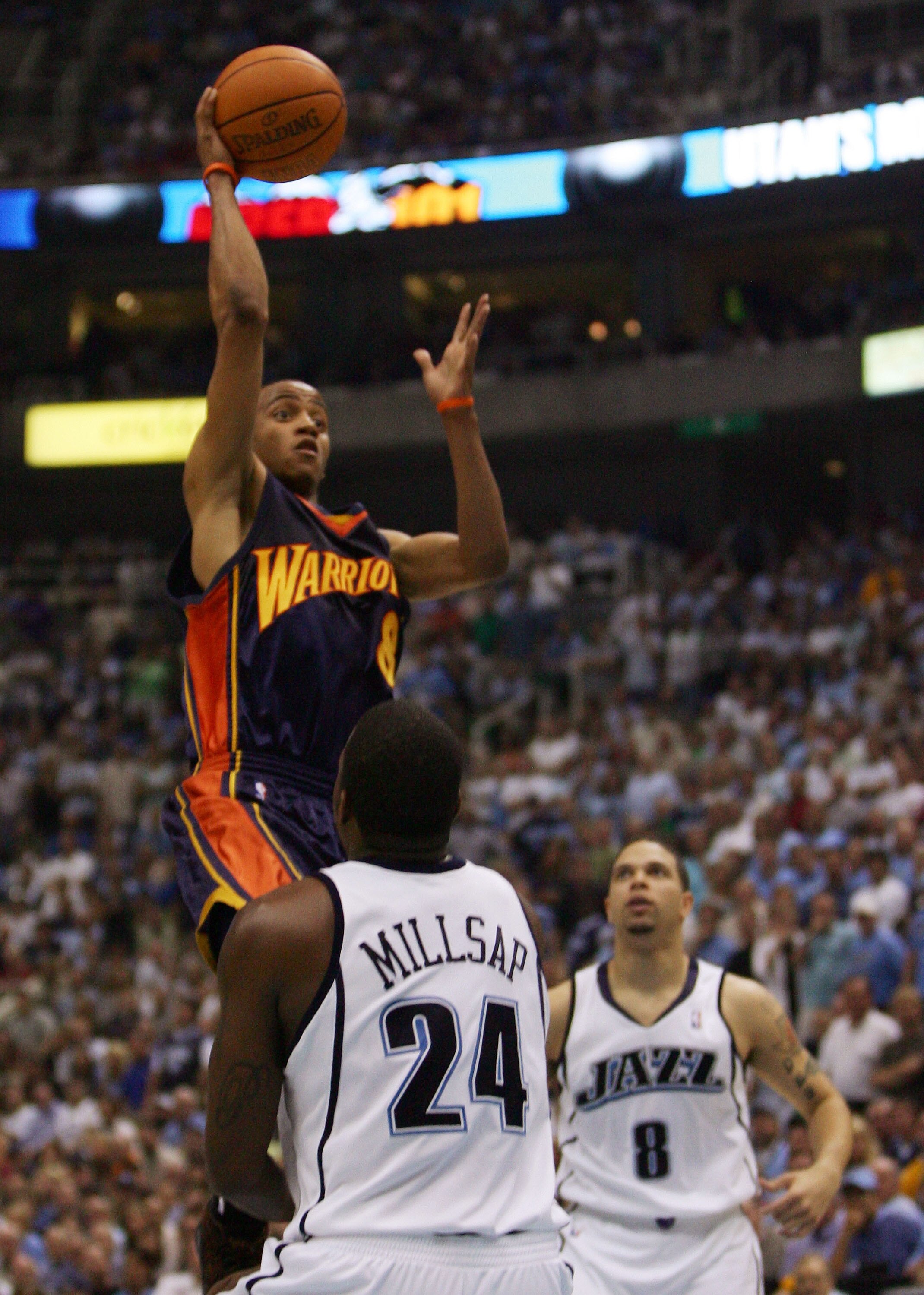 SALT LAKE CITY - MAY 15:  Monta Ellis #8 of the Golden State Warriors shoots over Paul Millsap #24 and Deron Williams #8 of the Utah Jazz during the second quarter in Game Five of the Western Conference Semifinals during the 2007 NBA Playoffs at the Energ