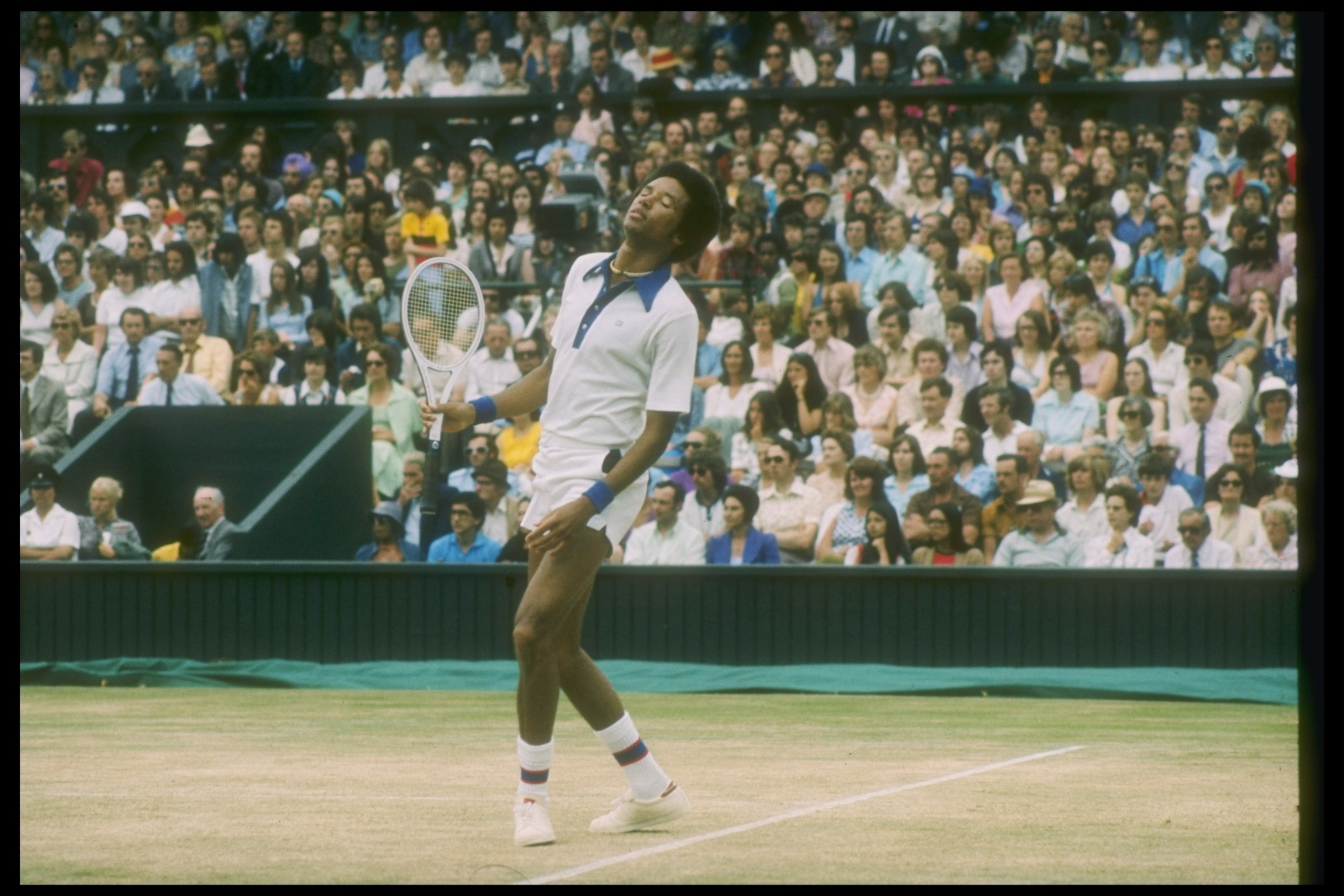 Jul 1975:  Arthur Ashe looks dejected during a match against Jimmy Connors at the Wimbledon Open in Great Britain. Mandatory Credit: Allsport  /Allsport