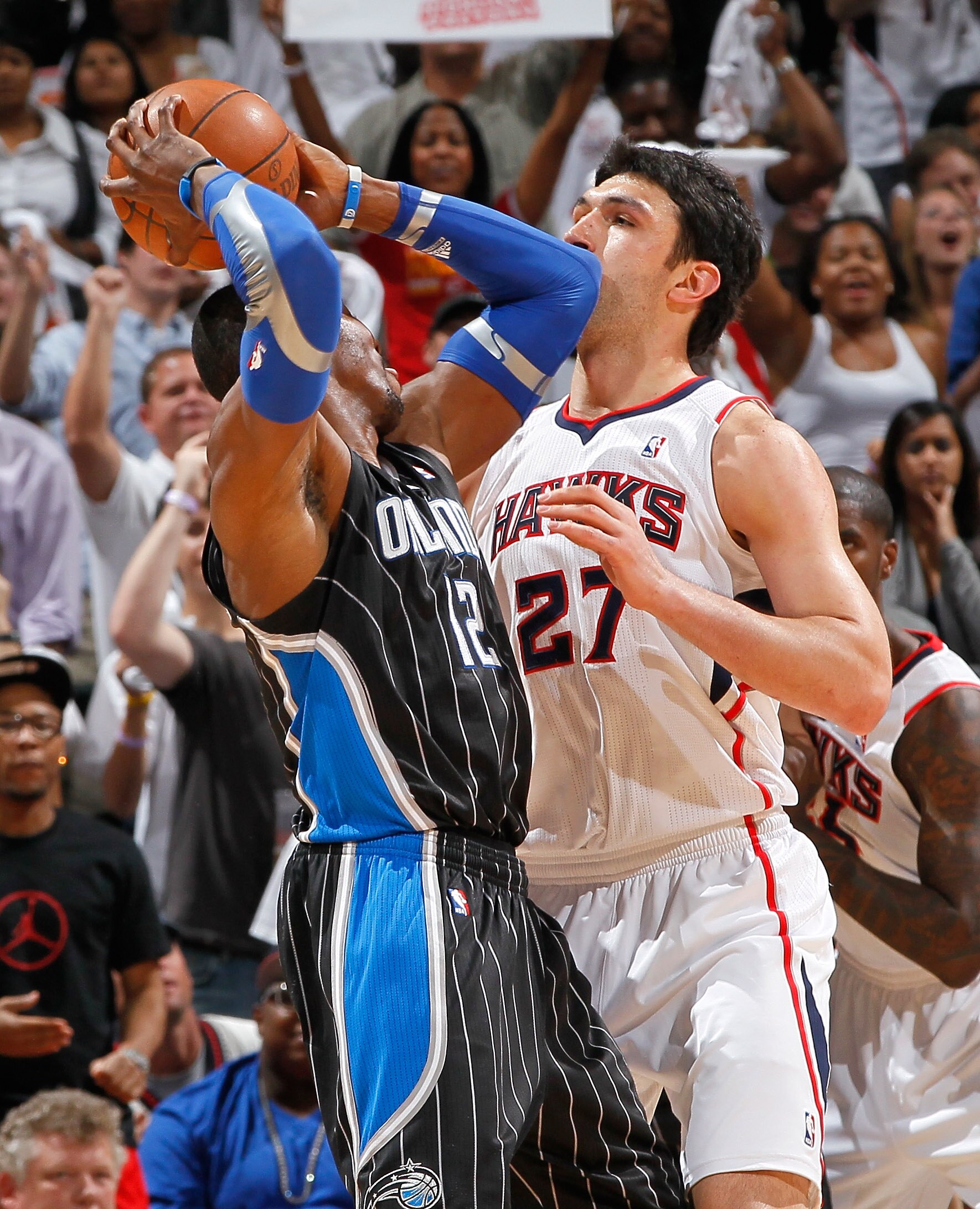 ATLANTA, GA - APRIL 28:  Dwight Howard #12 of the Orlando Magic against Zaza Pachulia #27 of the Atlanta Hawks during Game Six of the Eastern Conference Quarterfinals in the 2011 NBA Playoffs at Philips Arena on April 28, 2011 in Atlanta, Georgia.  NOTE T