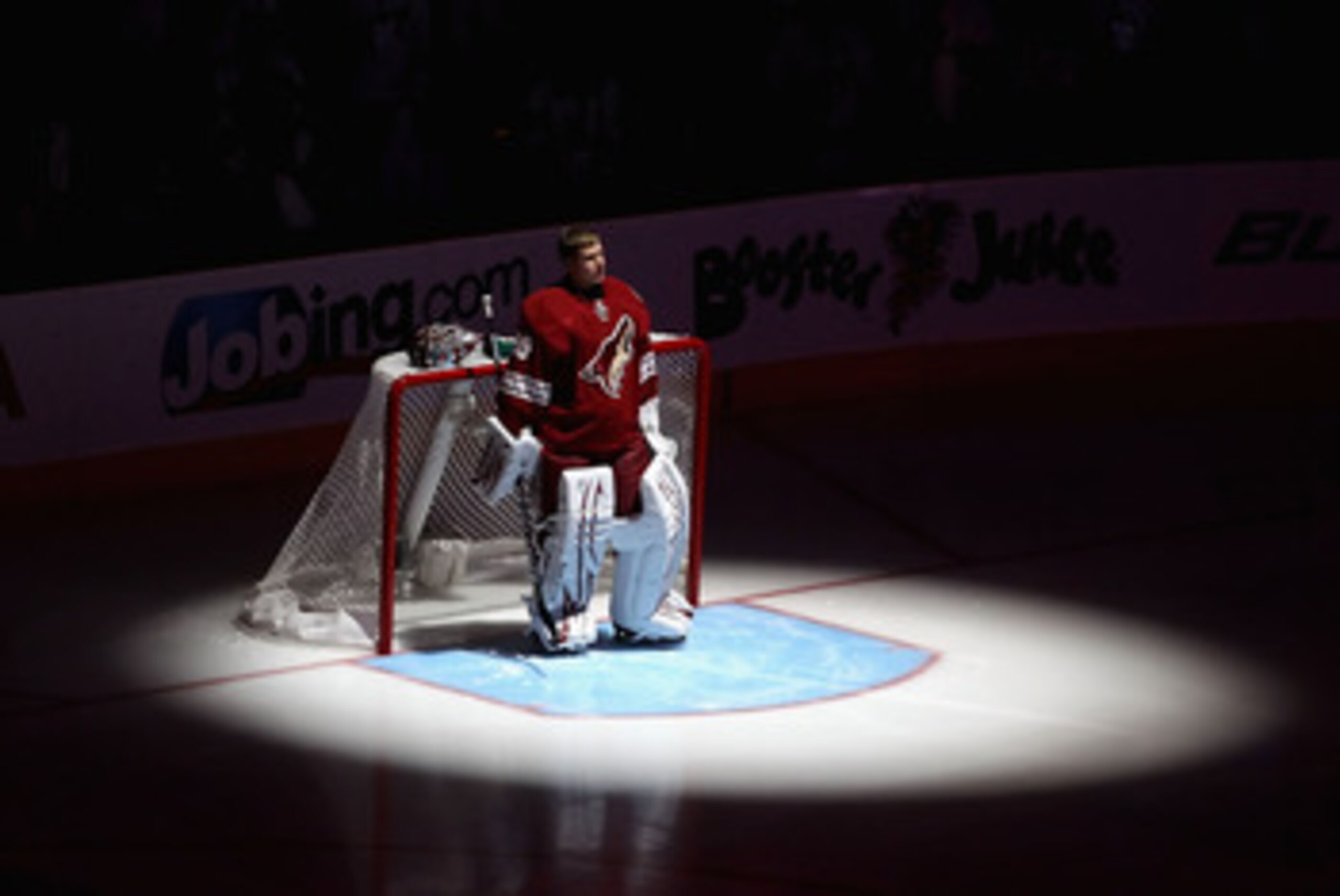 GLENDALE, AZ - APRIL 20:  Goaltender Ilya Bryzgalov #30 of the Phoenix Coyotes stands attended for the National Anthem before Game Four of the Western Conference Quarterfinals against the Detroit Red Wings during the 2011 NHL Stanley Cup Playoffs at Jobin