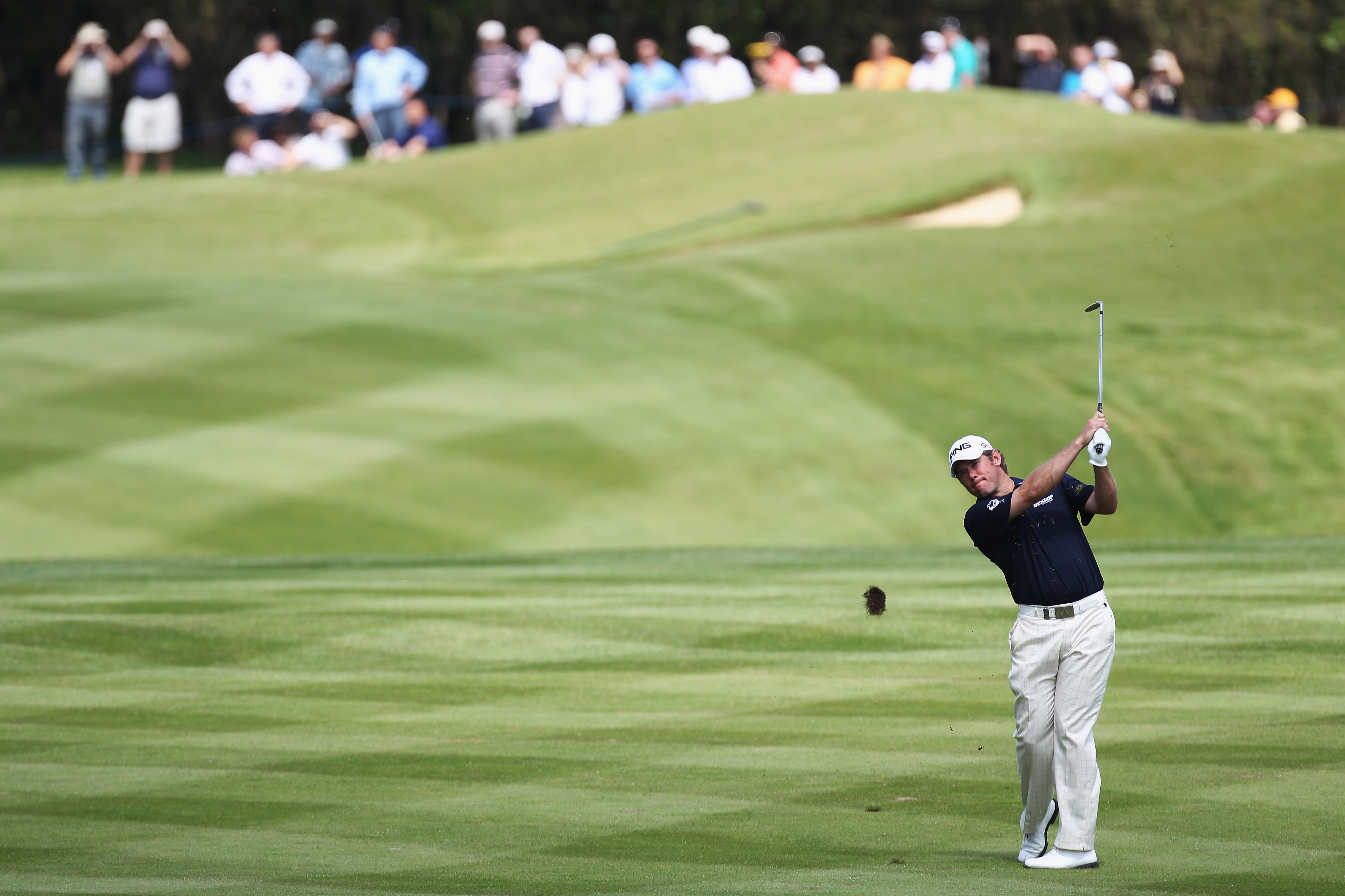 VIRGINIA WATER, ENGLAND - MAY 21:  Lee Westwood plays an iron shot at the 18th hole during the second round of the BMW PGA Championship on the West Course at Wentworth on May 21, 2010 in Virginia Water, England.  (Photo by Ross Kinnaird/Getty Images)