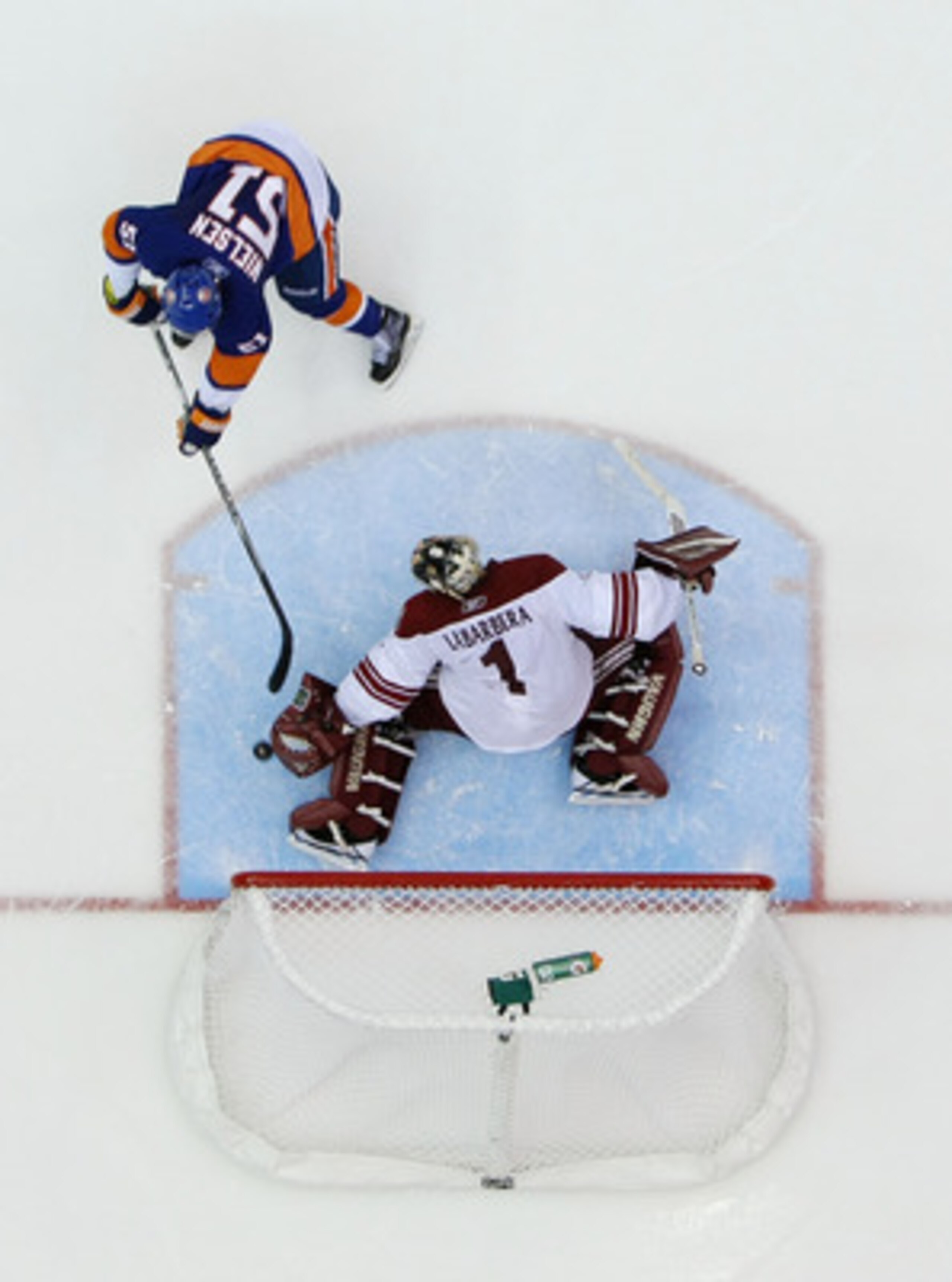 UNIONDALE, NY - DECEMBER 18:  Frans Nielsen #51 of the New York Islanders scores a shootout goal against Jason LaBarbara #1 of the Phoenix Coyotes during their game on December 18, 2010 at the Nassau Coliseum in Uniondale, New York.  (Photo by Al Bello/Ge
