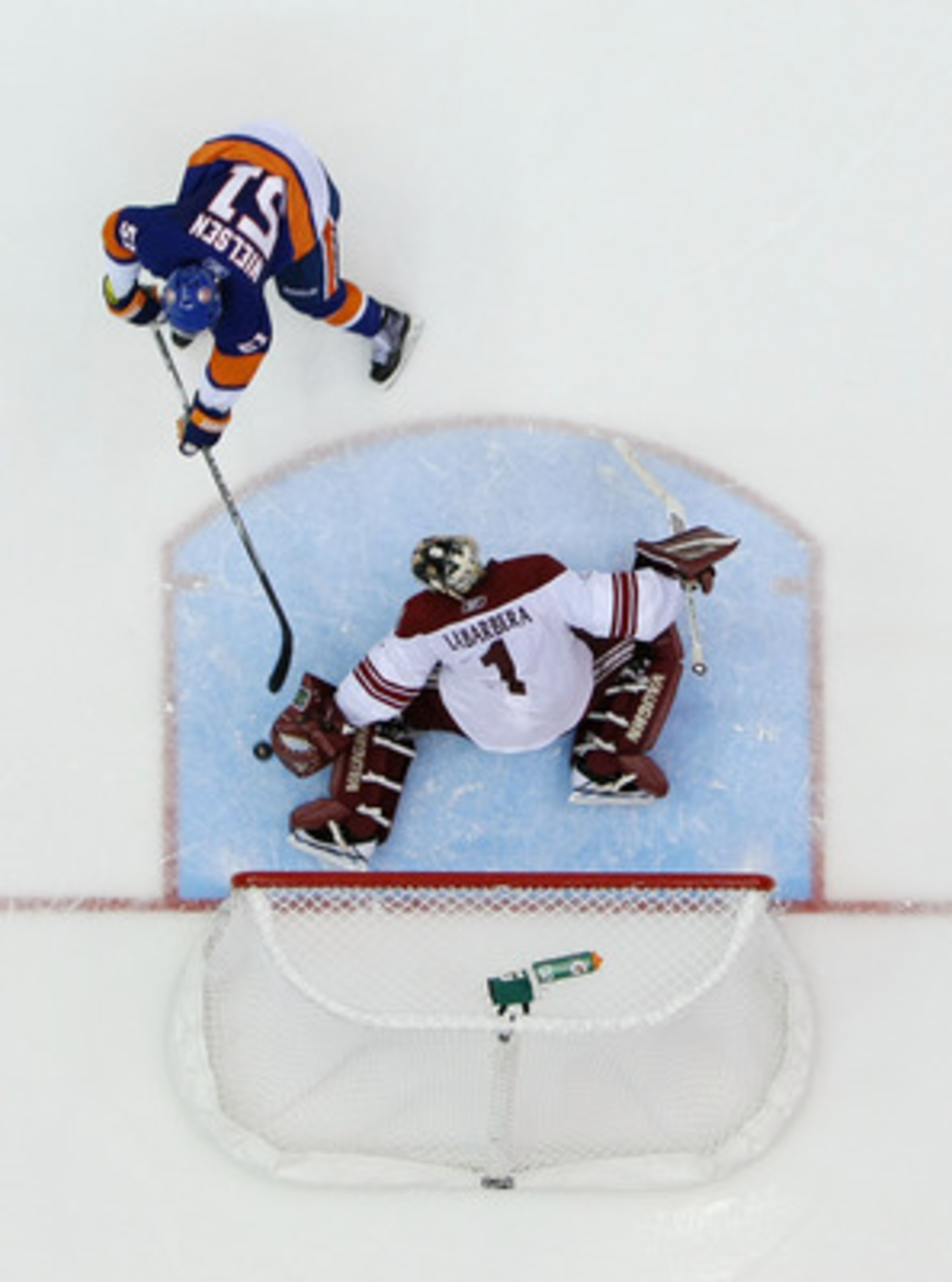 UNIONDALE, NY - DECEMBER 18:  Frans Nielsen #51 of the New York Islanders scores a shootout goal against Jason LaBarbara #1 of the Phoenix Coyotes during their game on December 18, 2010 at the Nassau Coliseum in Uniondale, New York.  (Photo by Al Bello/Ge
