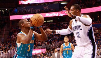 ORLANDO, FL - OCTOBER 10:  Chris Paul #3 of the New Orleans Hornets attempts a shot against Dwight Howard #12 of the Orlando Magic during the game at Amway Arena on October 10, 2010 in Orlando, Florida. NOTE TO USER: User expressly acknowledges and agrees