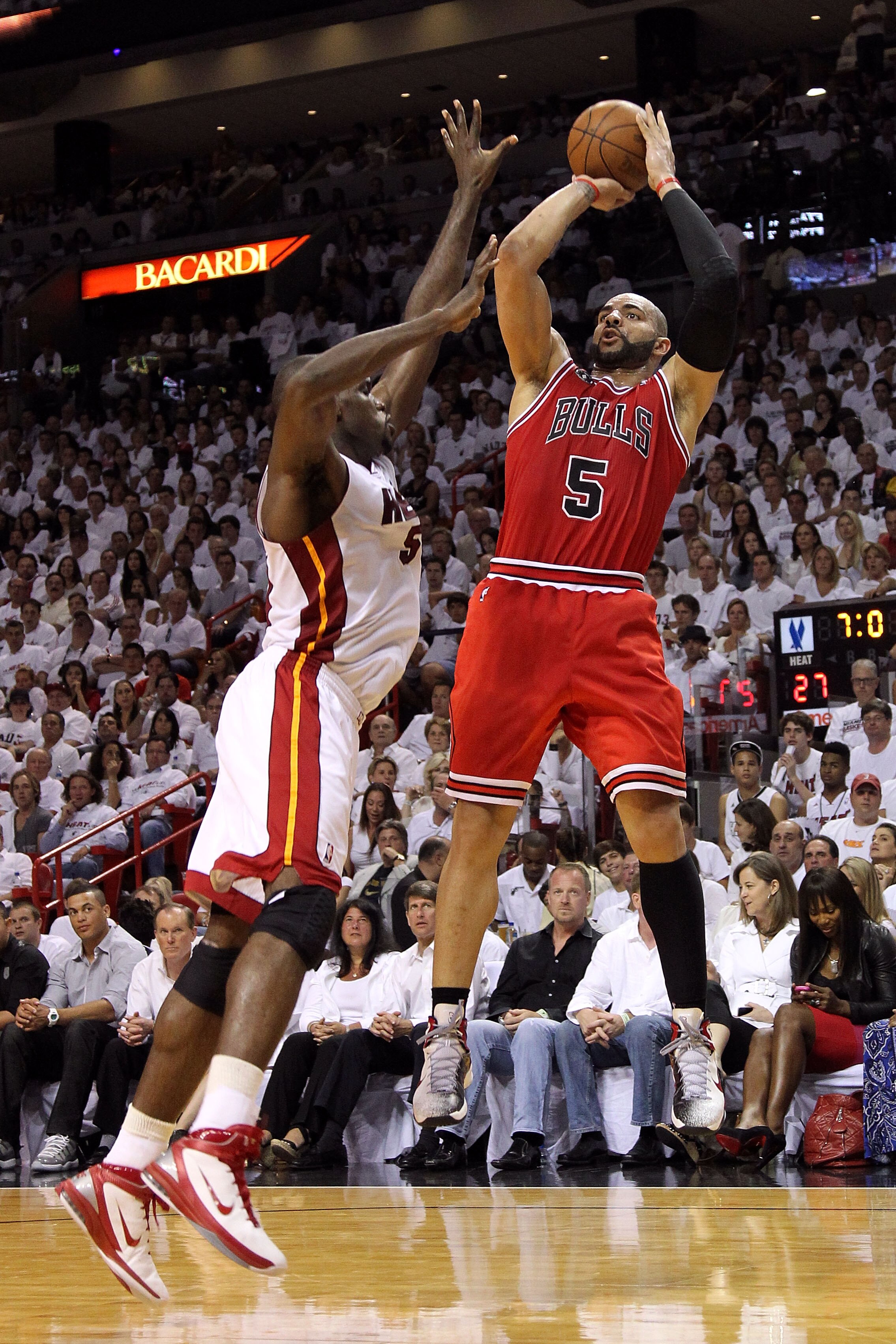 MIAMI, FL - MAY 22:  Carlos Boozer #5 of the Chicago Bulls attempts a shot against Joel Anthony #50 of the Miami Heat in Game Three of the Eastern Conference Finals during the 2011 NBA Playoffs on May 22, 2011 at American Airlines Arena in Miami, Florida.