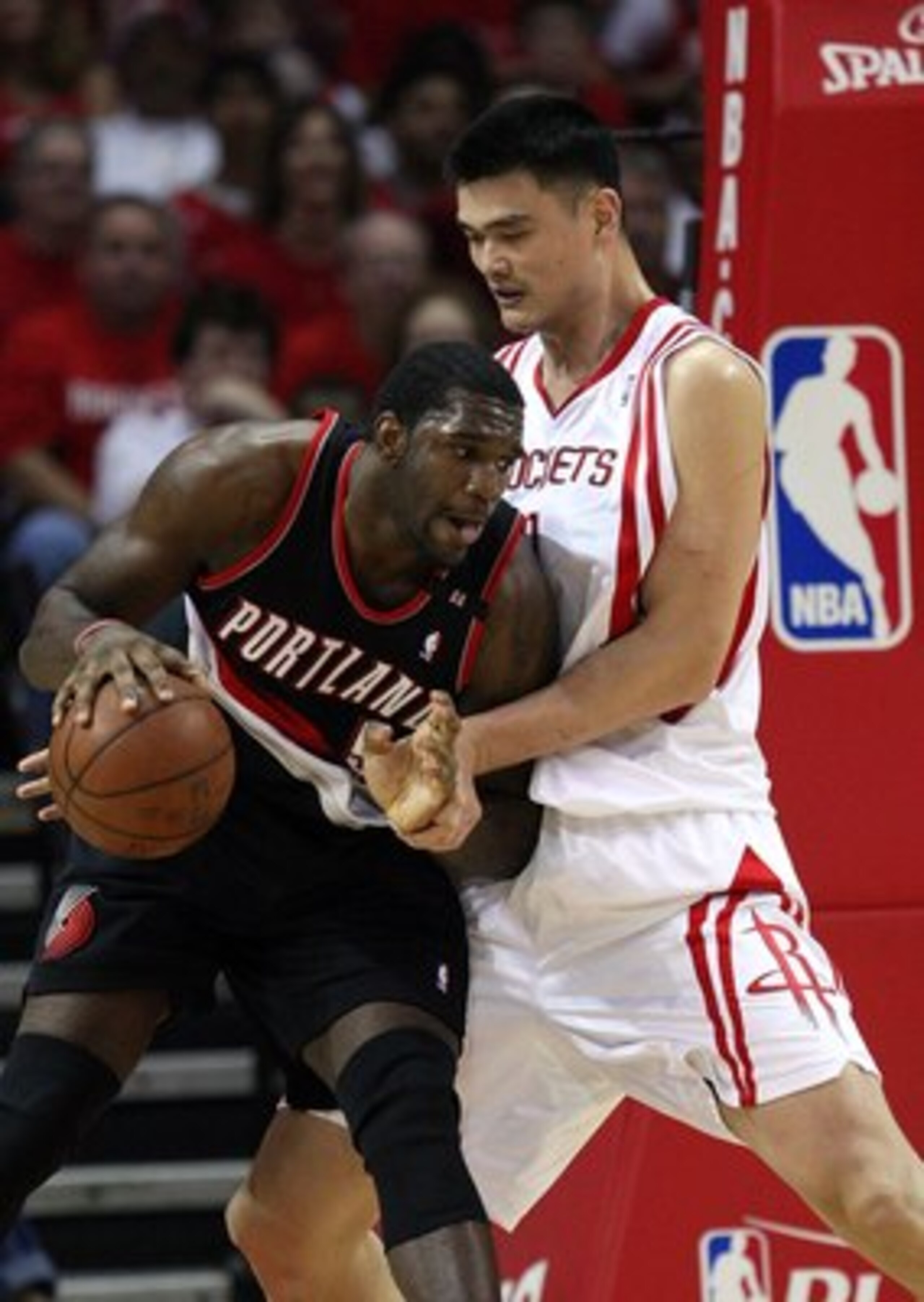 HOUSTON - APRIL 26:  Center Greg Oden #52 of the Portland Trail Blazers dribbles the ball against Yao Ming #11 of the Houston Rockets in Game Four of the Western Conference Quarterfinals during the 2009 NBA Playoffs at Toyota Center on April 26, 2009 in H