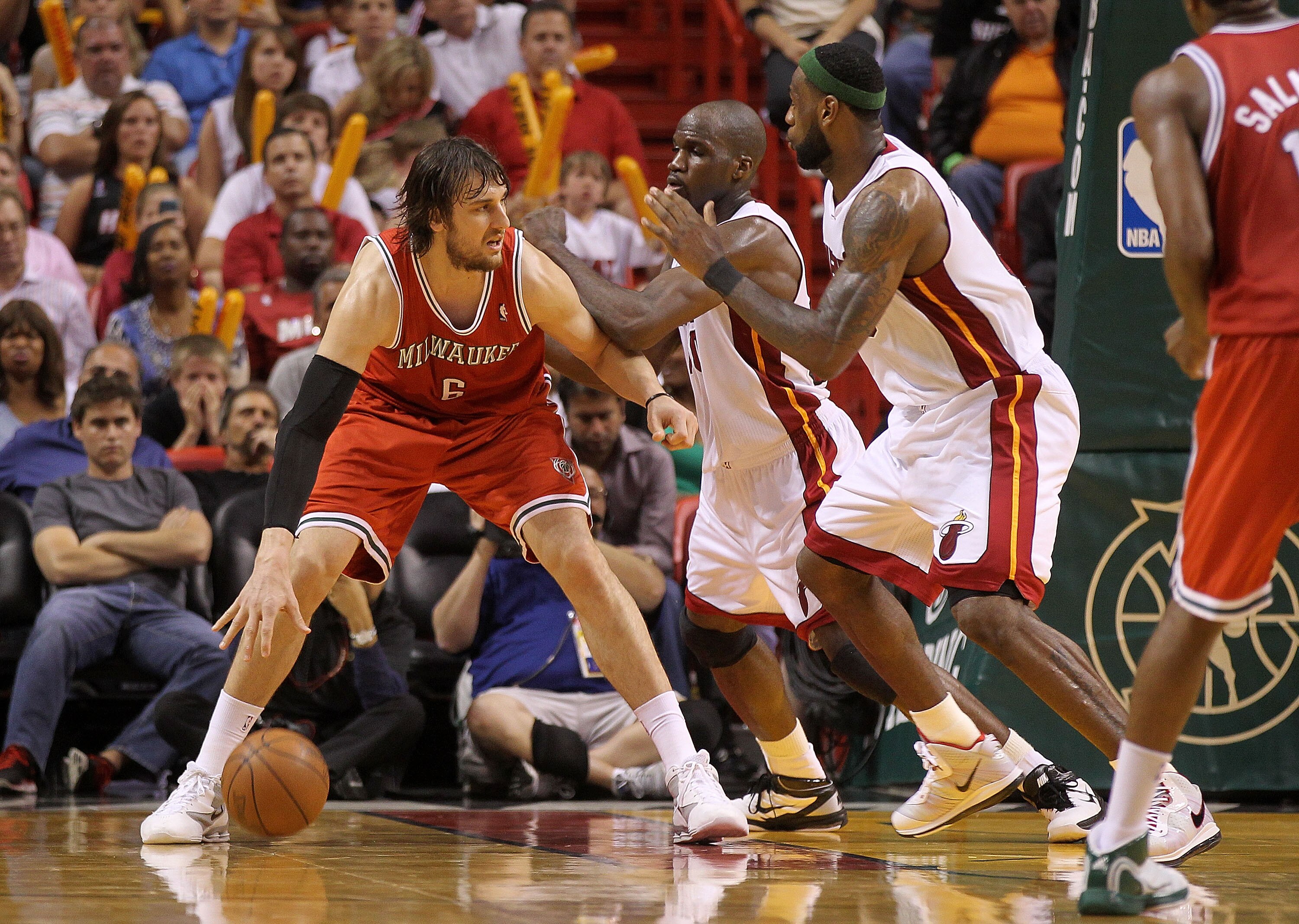 MIAMI, FL - APRIL 06:  Andrew Bogut #6 of the Milwaukee Bucks posts up  Joel Anthony #50 and LeBron James #6 of the Miami Heat during a game at American Airlines Arena on April 6, 2011 in Miami, Florida. NOTE TO USER: User expressly acknowledges and agree