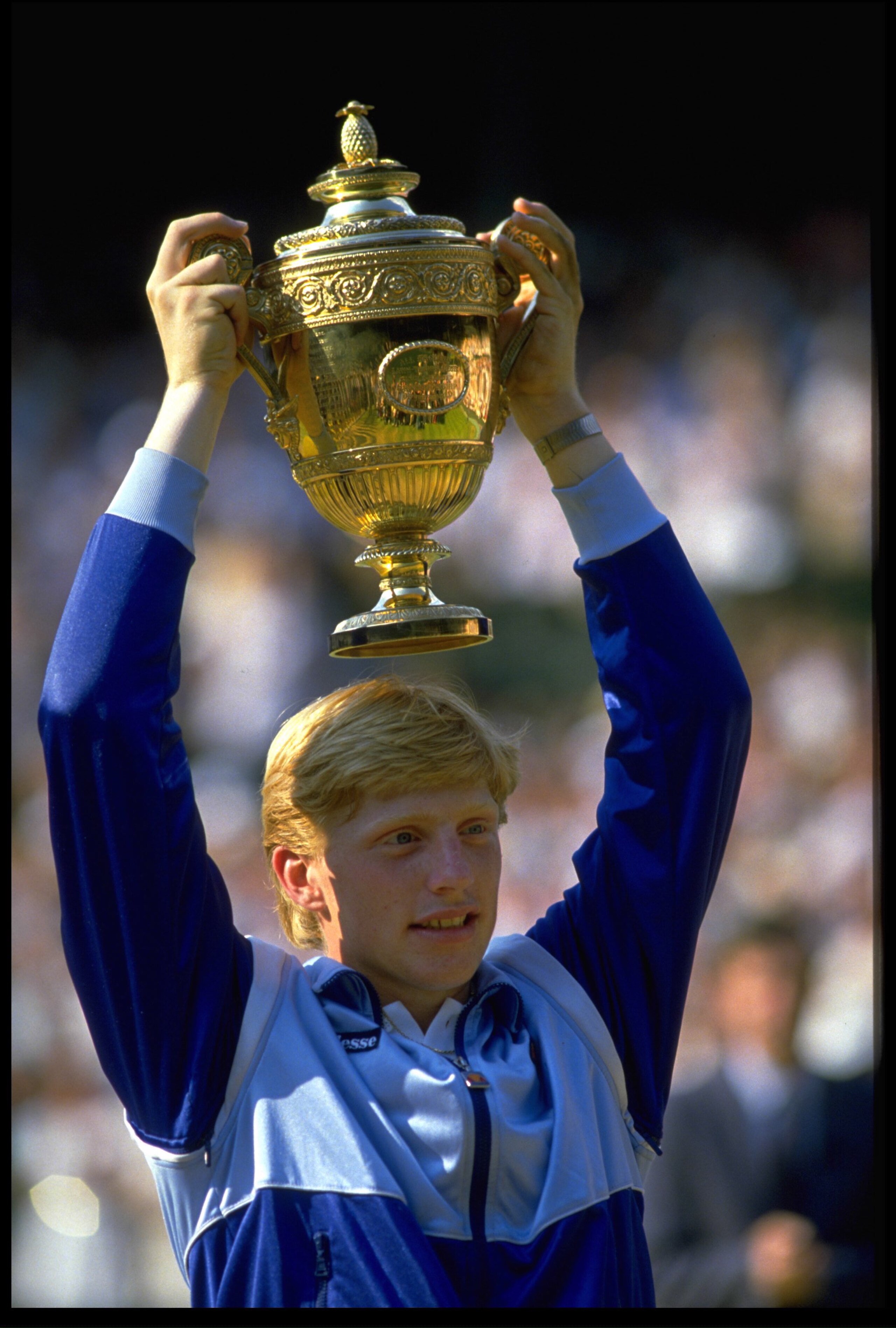 JUN 1985:  BORIS BECKER OF GERMANY HOLDS THE WIMBLEDON MENS SINGLES TROPHY ALOFT AFTER BEATING KEVIN CURREN.