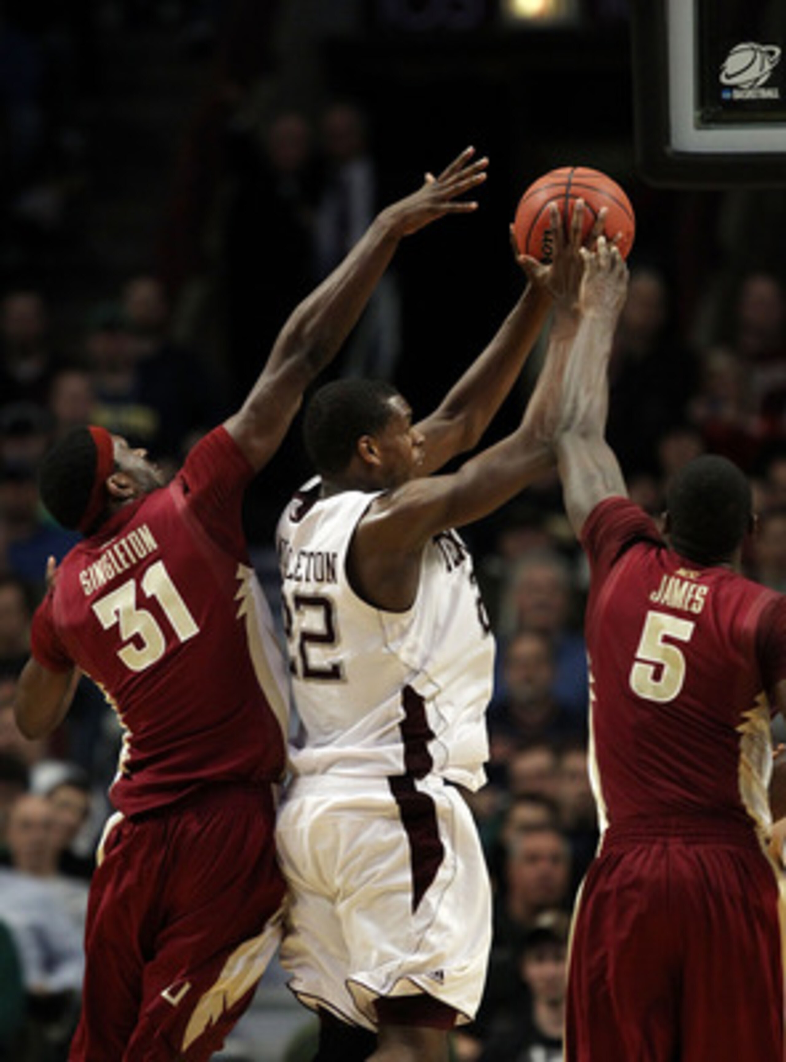 CHICAGO, IL - MARCH 18:  Khris Middleton #22 of the Texas A&M Aggies shoots against Chris Singleton #31 and Bernard James #5 of the Florida State Seminoles in the second half during the second round of the 2011 NCAA men's basketball tournament at the Unit