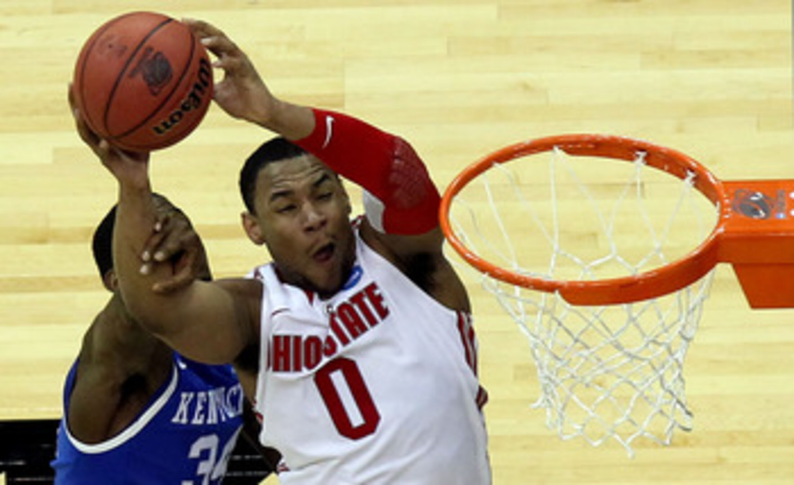 NEWARK, NJ - MARCH 25:  Jared Sullinger #0 of the Ohio State Buckeyes goes for a lay up against DeAndre Liggins #34 of the Kentucky Wildcats during the second half of the east regional semifinal of the 2011 NCAA Men's Basketball Tournament at the Prudenti
