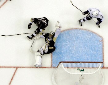 PITTSBURGH, PA - APRIL 27:  Marc-Andre Fleury #29 of the Pittsburgh Penguins makes a glove save against the Tampa Bay Lightning in Game Seven of the Eastern Conference Quarterfinals during the 2011 NHL Stanley Cup Playoffs at Consol Energy Center on April