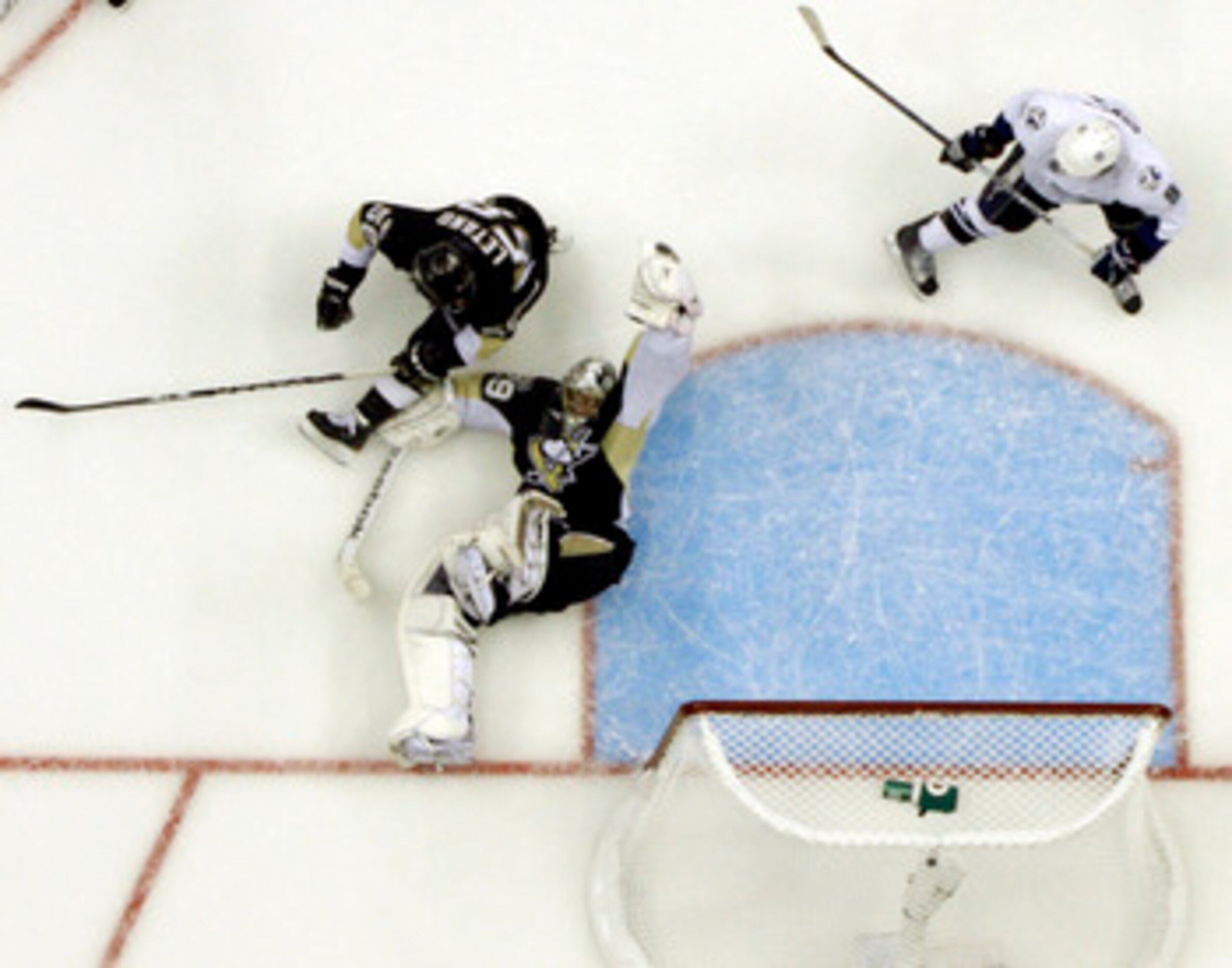 PITTSBURGH, PA - APRIL 27:  Marc-Andre Fleury #29 of the Pittsburgh Penguins makes a glove save against the Tampa Bay Lightning in Game Seven of the Eastern Conference Quarterfinals during the 2011 NHL Stanley Cup Playoffs at Consol Energy Center on April