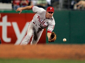 PITTSBURGH, PA - JUNE 04:  Chase Utley #26 of the Philadelphia Phillies fields a ground ball against the Pittsburgh Pirates during the game on June 4, 2011 at PNC Park in Pittsburgh, Pennsylvania.  The Pirates defeated the Phillies 6-3.  (Photo by Justin