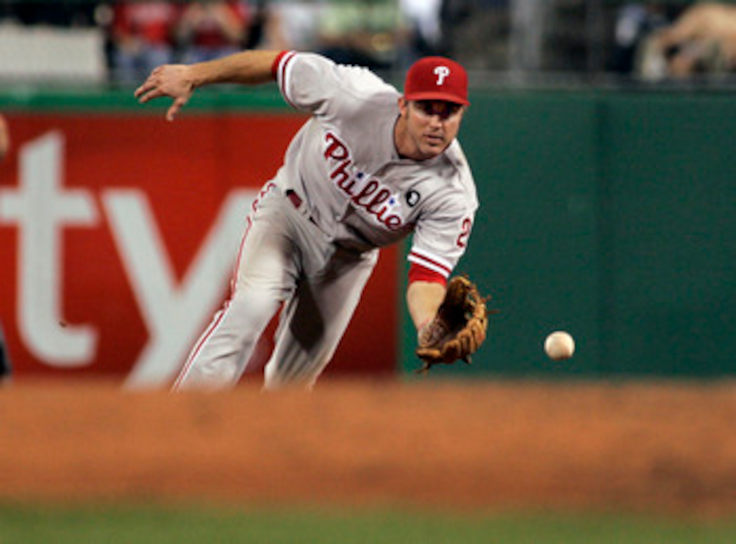 PITTSBURGH, PA - JUNE 04:  Chase Utley #26 of the Philadelphia Phillies fields a ground ball against the Pittsburgh Pirates during the game on June 4, 2011 at PNC Park in Pittsburgh, Pennsylvania.  The Pirates defeated the Phillies 6-3.  (Photo by Justin
