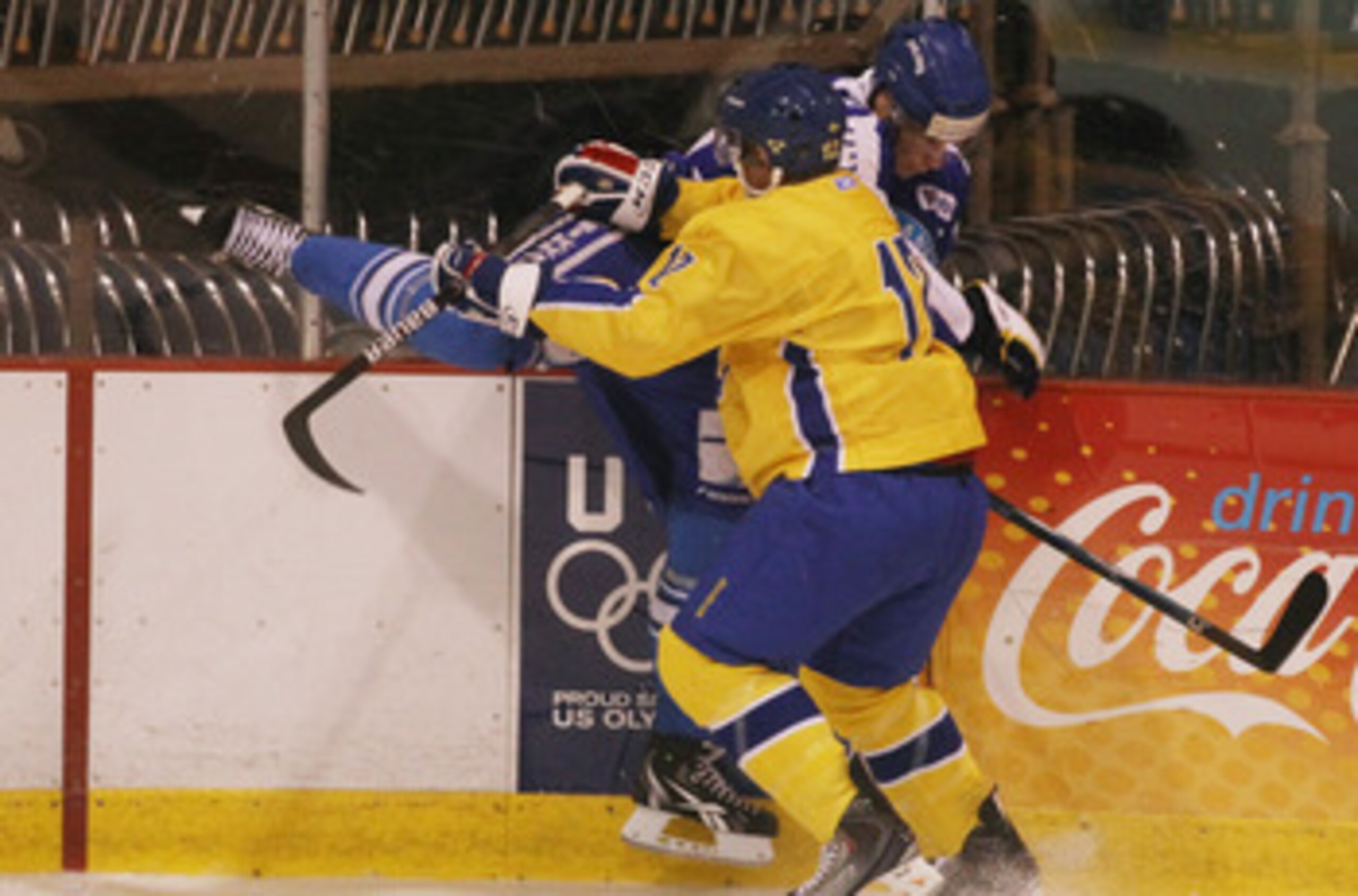 LAKE PLACID, NY - AUGUST 05:  Jonnas Nattinen #29  of Team Finland is hit into the boards by Gabriel Landeskog #12 of Team Sweden at the USA Hockey National Evaluation Camp on August 5, 2010 in Lake Placid, New York.  (Photo by Bruce Bennett/Getty Images)