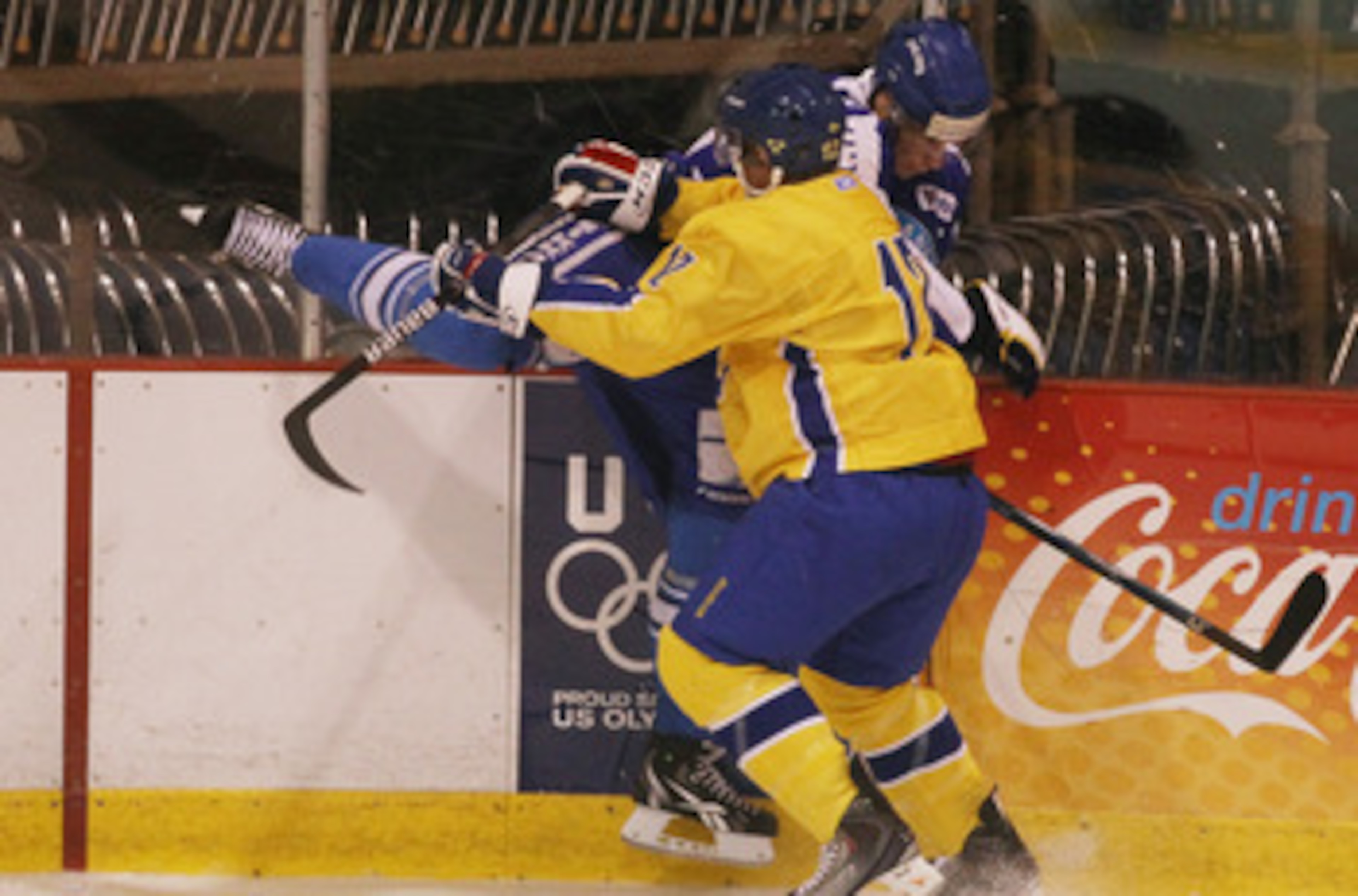 LAKE PLACID, NY - AUGUST 05:  Jonnas Nattinen #29  of Team Finland is hit into the boards by Gabriel Landeskog #12 of Team Sweden at the USA Hockey National Evaluation Camp on August 5, 2010 in Lake Placid, New York.  (Photo by Bruce Bennett/Getty Images)