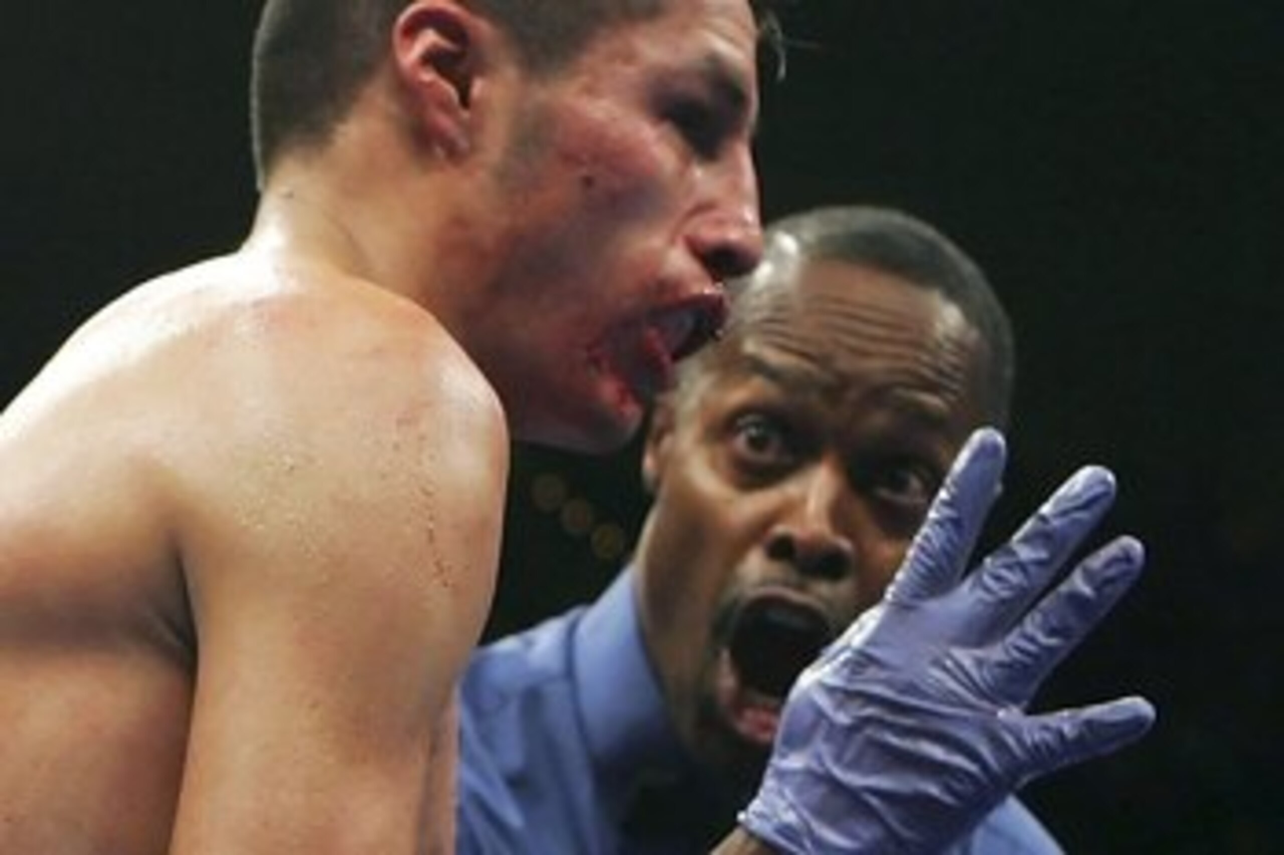 LAS VEGAS - SEPTEMBER 16:  Jhonny Gonzalez of Mexico sits on the mat as referee Kenny Bayless counts as Israel Vazquez waits in the corner in the 10th round during their WBC super bantamweight titile fight at the MGM Grand Garden Arena September 16, 2006 