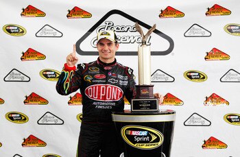 LONG POND, PA - JUNE 12:  Jeff Gordon, driver of the #24 DuPont Chevrolet, celebrates with the trophy after winning the NASCAR Sprint Cup Series 5-Hour Energy 500 at Pocono Raceway on June 12, 2011 in Long Pond, Pennsylvania.  (Photo by Geoff Burke/Getty 