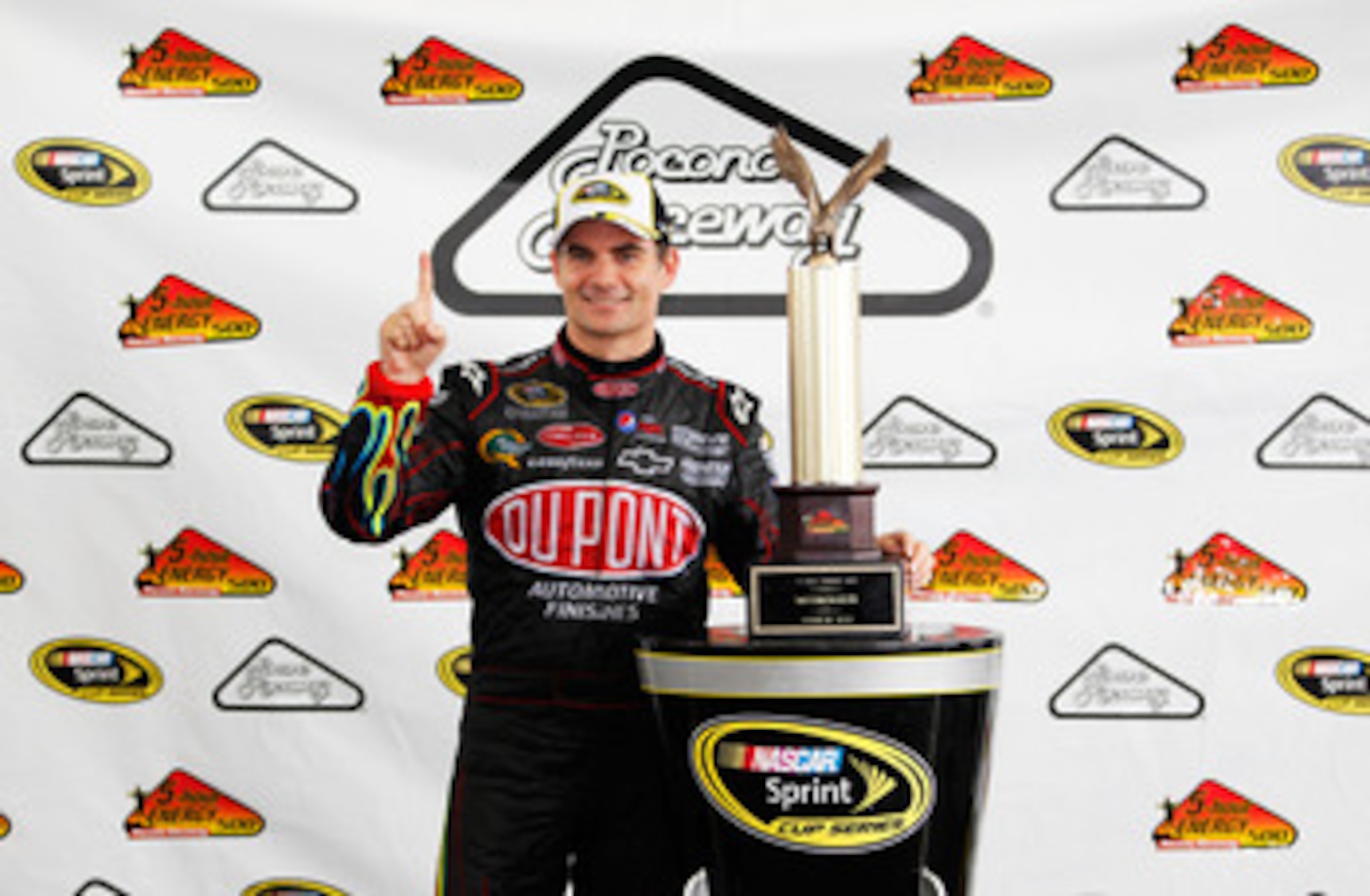 LONG POND, PA - JUNE 12:  Jeff Gordon, driver of the #24 DuPont Chevrolet, celebrates with the trophy after winning the NASCAR Sprint Cup Series 5-Hour Energy 500 at Pocono Raceway on June 12, 2011 in Long Pond, Pennsylvania.  (Photo by Geoff Burke/Getty 