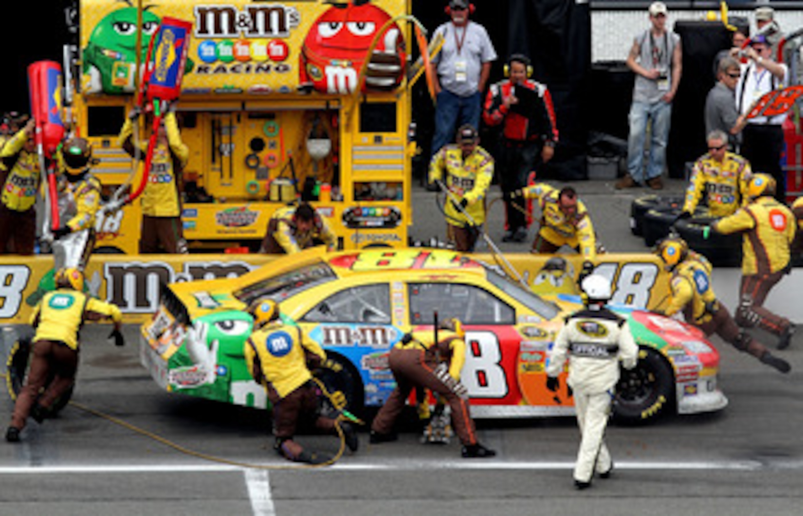 LONG POND, PA - JUNE 12:  Kyle Busch, driver of the #18 M&M's Toyota, makes a pit stop during the NASCAR Sprint Cup Series 5-Hour Energy 500 at Pocono Raceway on June 12, 2011 in Long Pond, Pennsylvania.  (Photo by Jerry Markland/Getty Images for NASCAR)