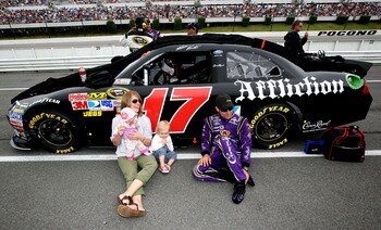 LONG POND, PA - JUNE 12:  Matt Kenseth, driver of the #17 Affliction Clothing: Live Fast Ford, talks with his wife Katie and daughters Kaylin and Grace prior to the start of the NASCAR Sprint Cup Series 5-Hour Energy 500 at Pocono Raceway on June 12, 2011