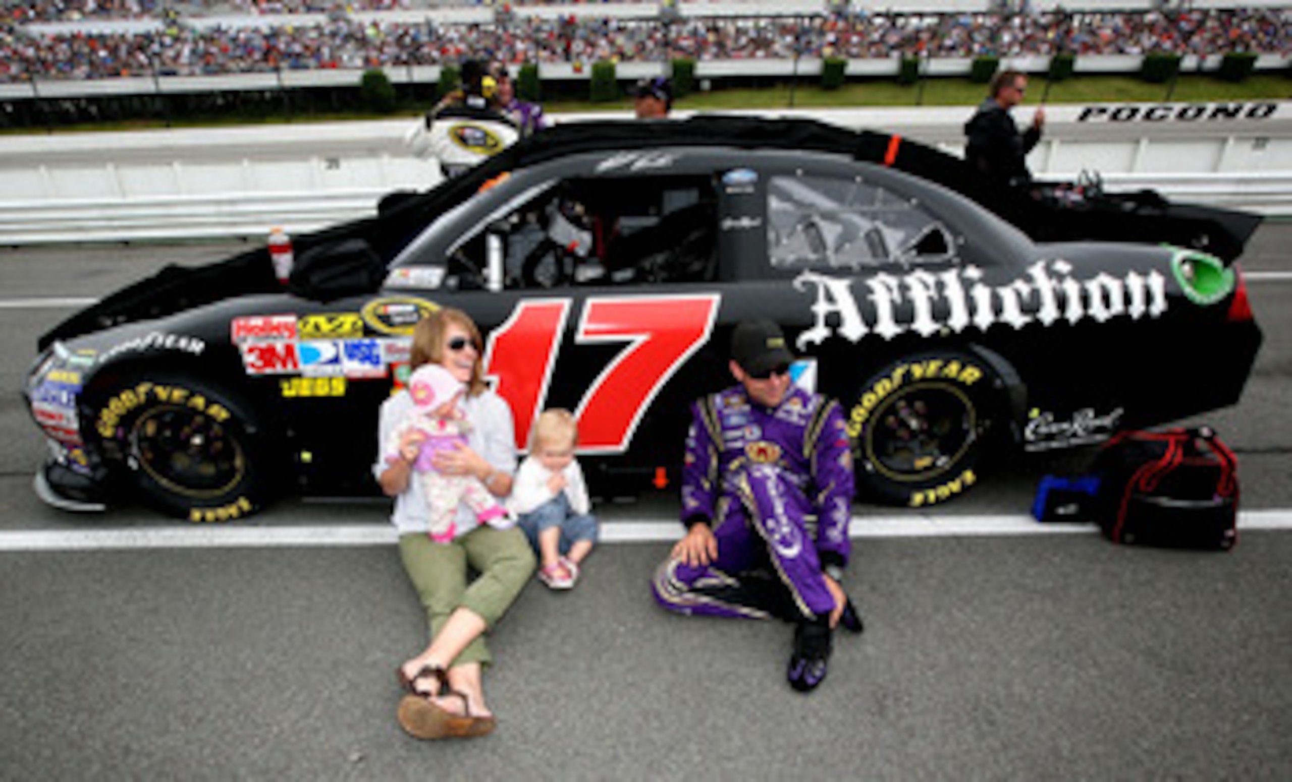 LONG POND, PA - JUNE 12:  Matt Kenseth, driver of the #17 Affliction Clothing: Live Fast Ford, talks with his wife Katie and daughters Kaylin and Grace prior to the start of the NASCAR Sprint Cup Series 5-Hour Energy 500 at Pocono Raceway on June 12, 2011