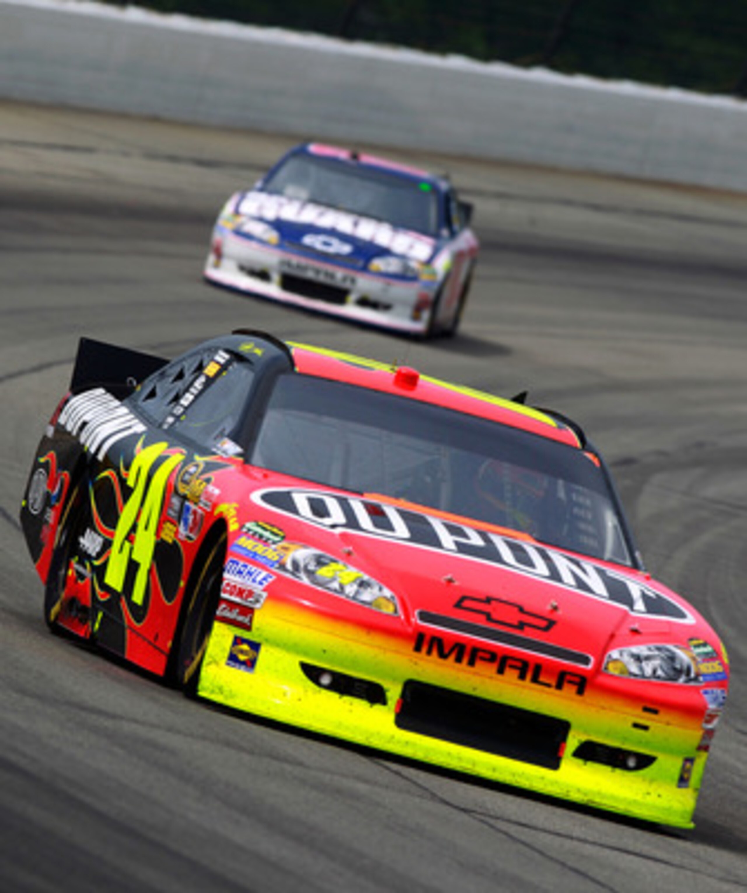 LONG POND, PA - JUNE 12:  Jeff Gordon, driver of the #24 DuPont Chevrolet, leads Dale Earnhardt Jr., driver of the #88 National Guard/Amp Energy Chevrolet, during the NASCAR Sprint Cup Series 5-Hour Energy 500 at Pocono Raceway on June 12, 2011 in Long Po