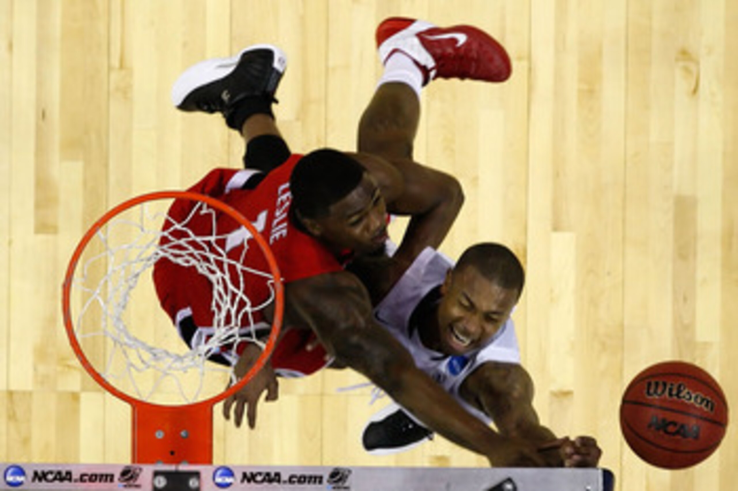 CHARLOTTE, NC - MARCH 18:  Isaiah Thomas #2 of the Washington Huskies goes up for a shot against Travis Leslie #1 of the Georgia Bulldogs during the second round of the 2011 NCAA men's basketball tournament at Time Warner Cable Arena on March 18, 2011 in 
