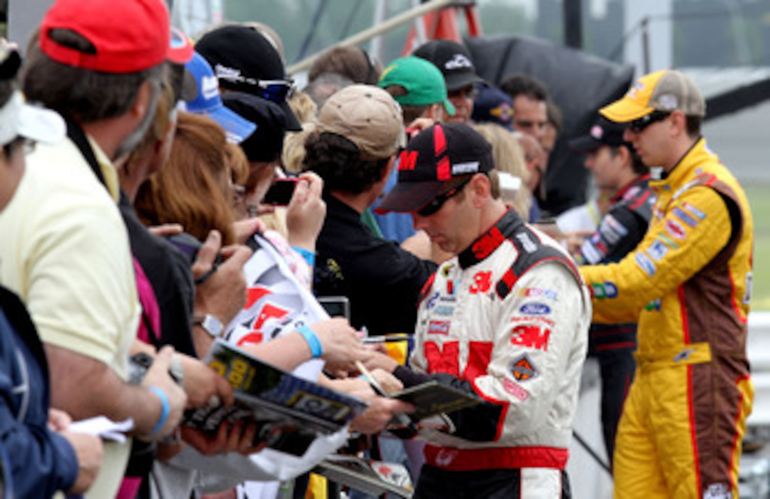 LONG POND, PA - JUNE 11:  Greg Biffle, driver of the #16 3M Ford, signs autographs during qualifying for the NASCAR Sprint Cup Series 5-Hour Energy 500 at Pocono Raceway on June 11, 2011 in Long Pond, Pennsylvania.  (Photo by Jerry Markland/Getty Images f