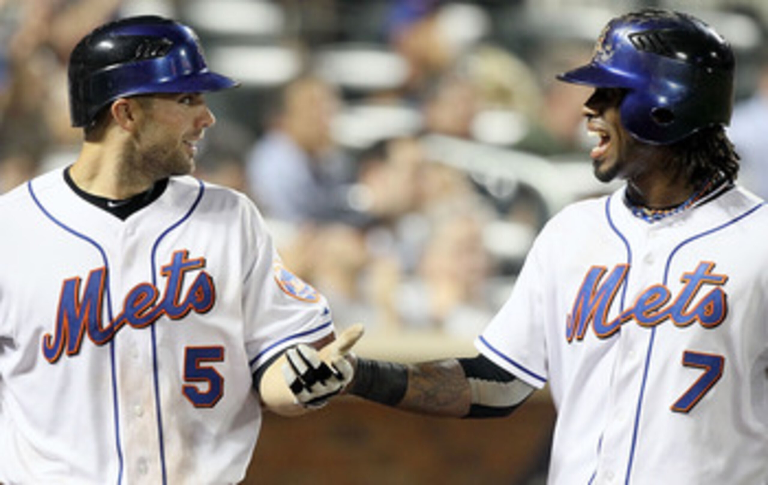 NEW YORK - JULY 06:  Jose Reyes #7 and David Wright #5 of the New York Mets celebrate after scoring in the sixth inning against the Cincinnati Reds on July 6, 2010 at Citi Field in the Flushing neighborhood of the Queens borough of New York City.  (Photo